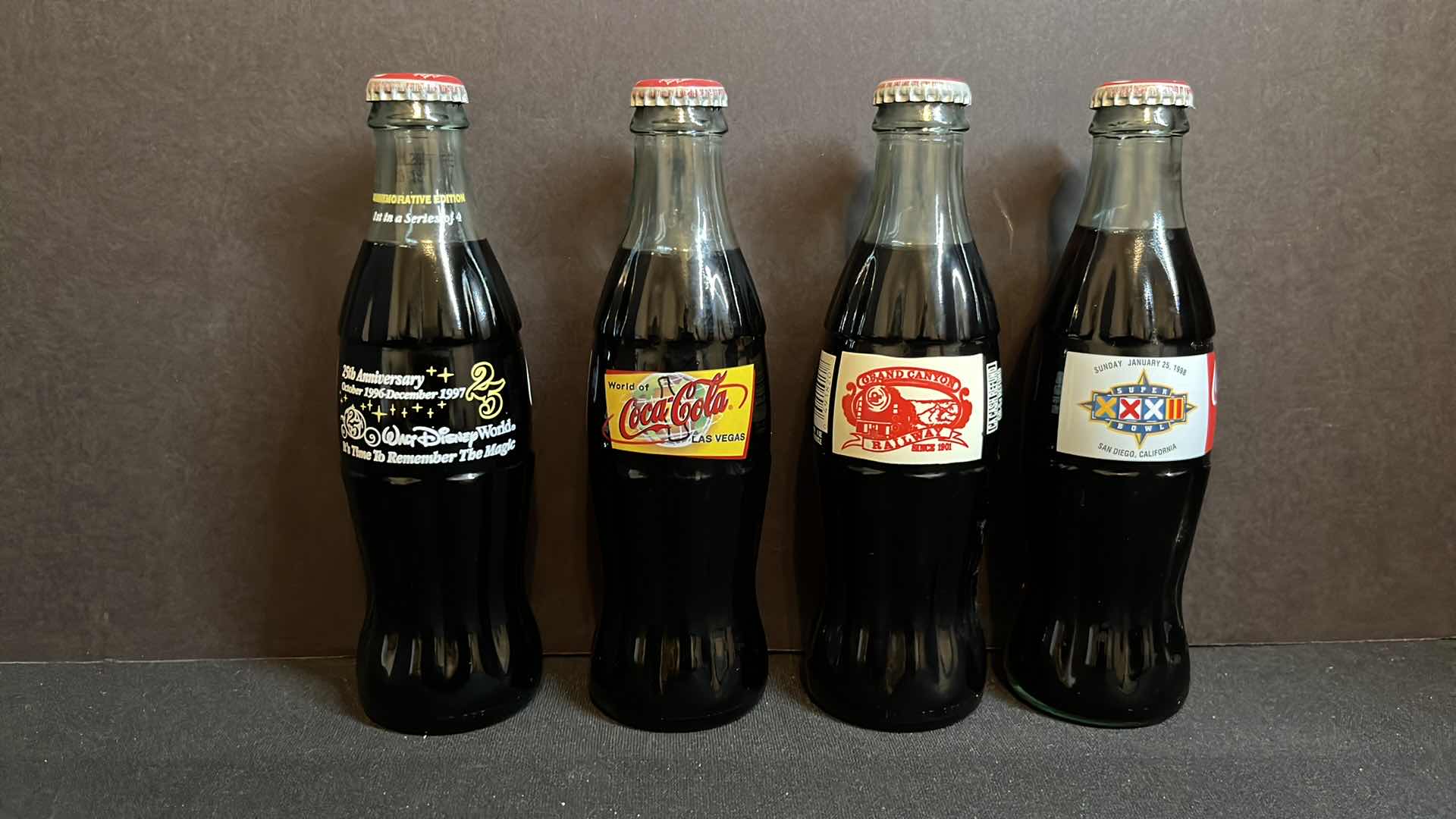 Photo 1 of COCA-COLA 4-COMMEMORATIVE 8 OZ BOTTLES, 25TH ANNIVERSARY DISNEY WORLD 1996, WORLD OF COCA-COLA LAS VEGAS 1996, GRAND CANYON RAILWAY 1997, SUPER BOWL XXXII SAN DIEGO 1998, UNOPENED