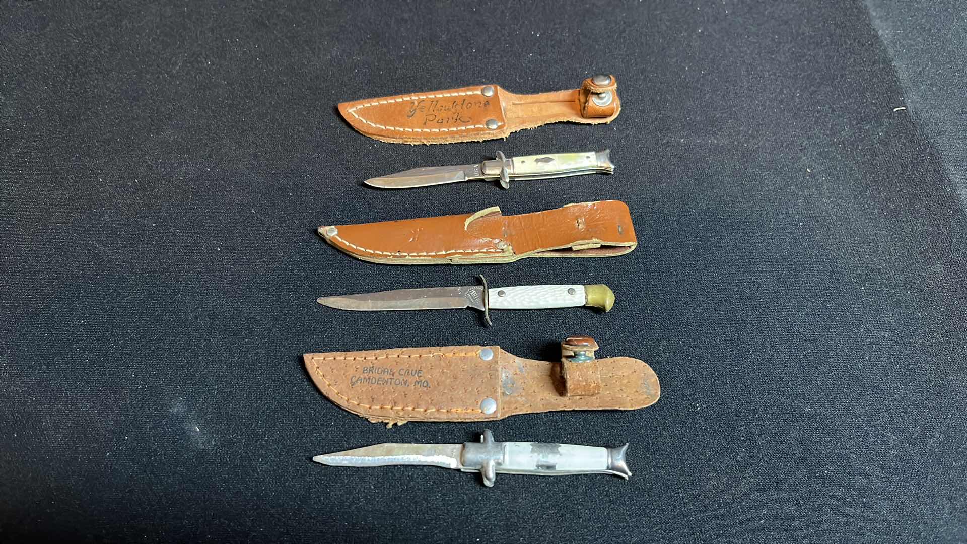 Photo 1 of COLLECTIBLE 4-ARROW PENCILS WITH BAG & 5-MINIATURE KNIVES W LEATHER SHEATHS 4”