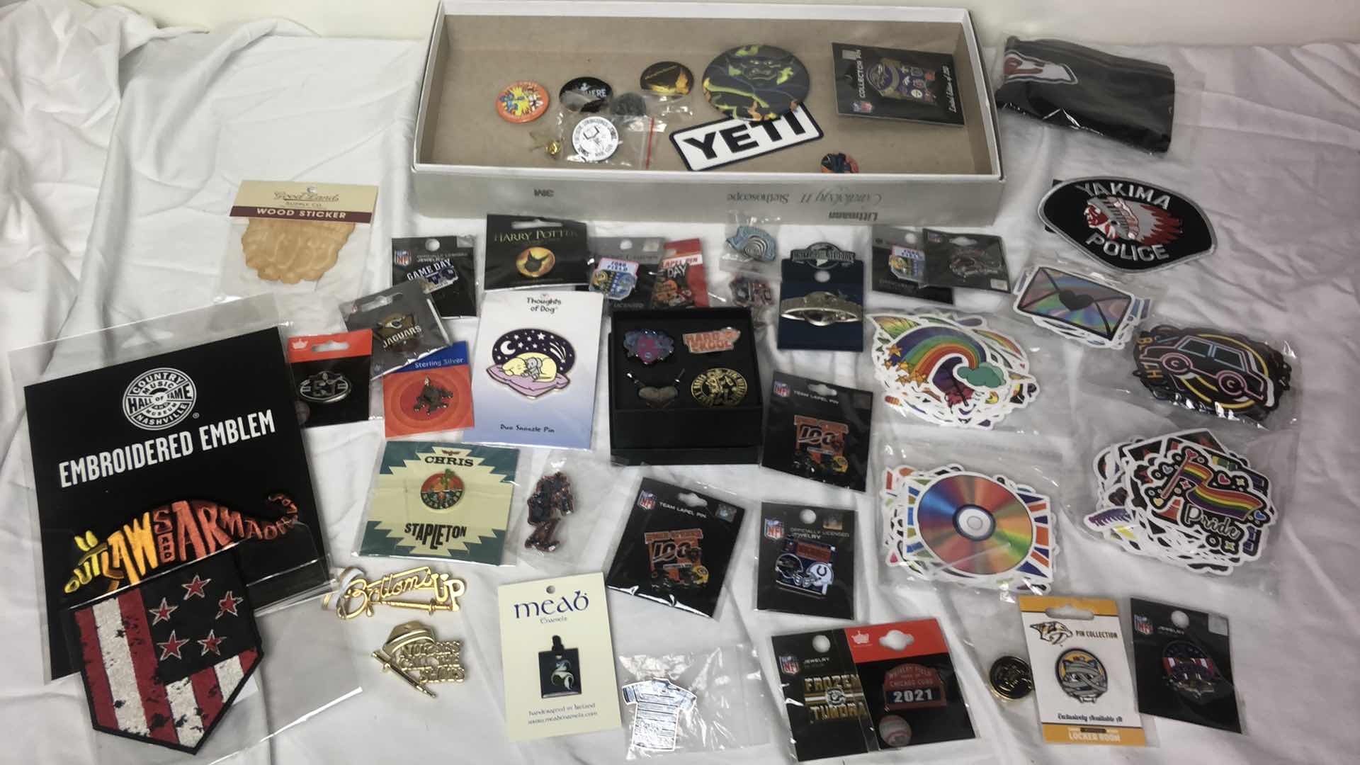 Photo 1 of BOX OF APPROX 200 STICKER DECALS AND 50 METAL PINS (GUN N ROSES, NFL FOOTBALL, MISC AND MORE