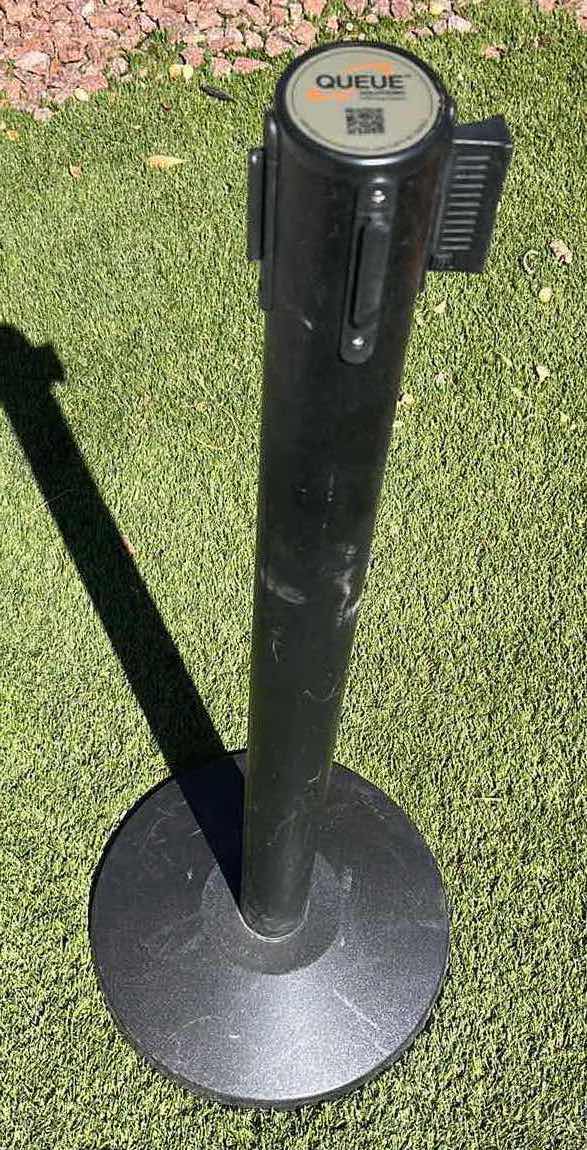 Photo 1 of QUEUE SOLUTIONS SINGLE BELT 3 WAY ATTACHMENT BLACK COATED METAL STANCHION 13.5” X 40.5” W 10.5FT RED NYLON BELT DIVIDER