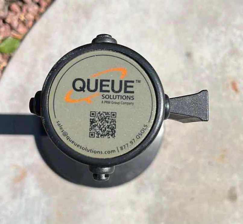 Photo 1 of QUEUE SOLUTIONS SINGLE BELT 3 WAY ATTACHMENT BLACK COATED METAL STANCHION 13.5” X 40.5” W 10.5FT RED NYLON BELT DIVIDER