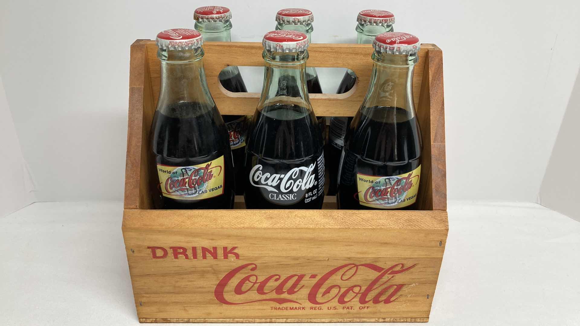 Photo 1 of COCA-COLA WORLD COCA-COLA LAS VEGAS GLASS SEALED BOTTLES (6) W WOOD CARRIER