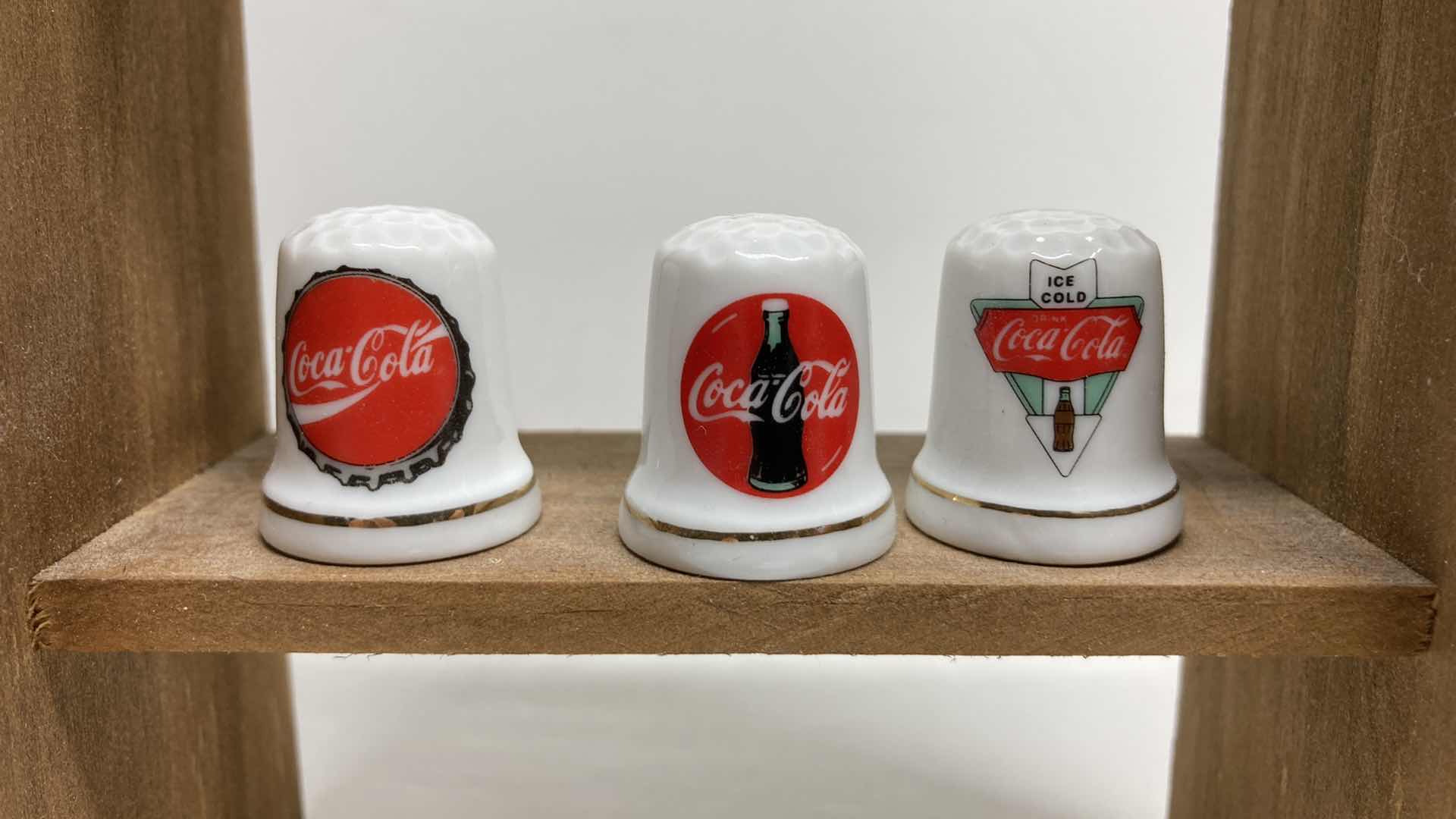 Photo 1 of COCA-COLA THIMBLES W WOOD RACK 4.5” X 3” H8”