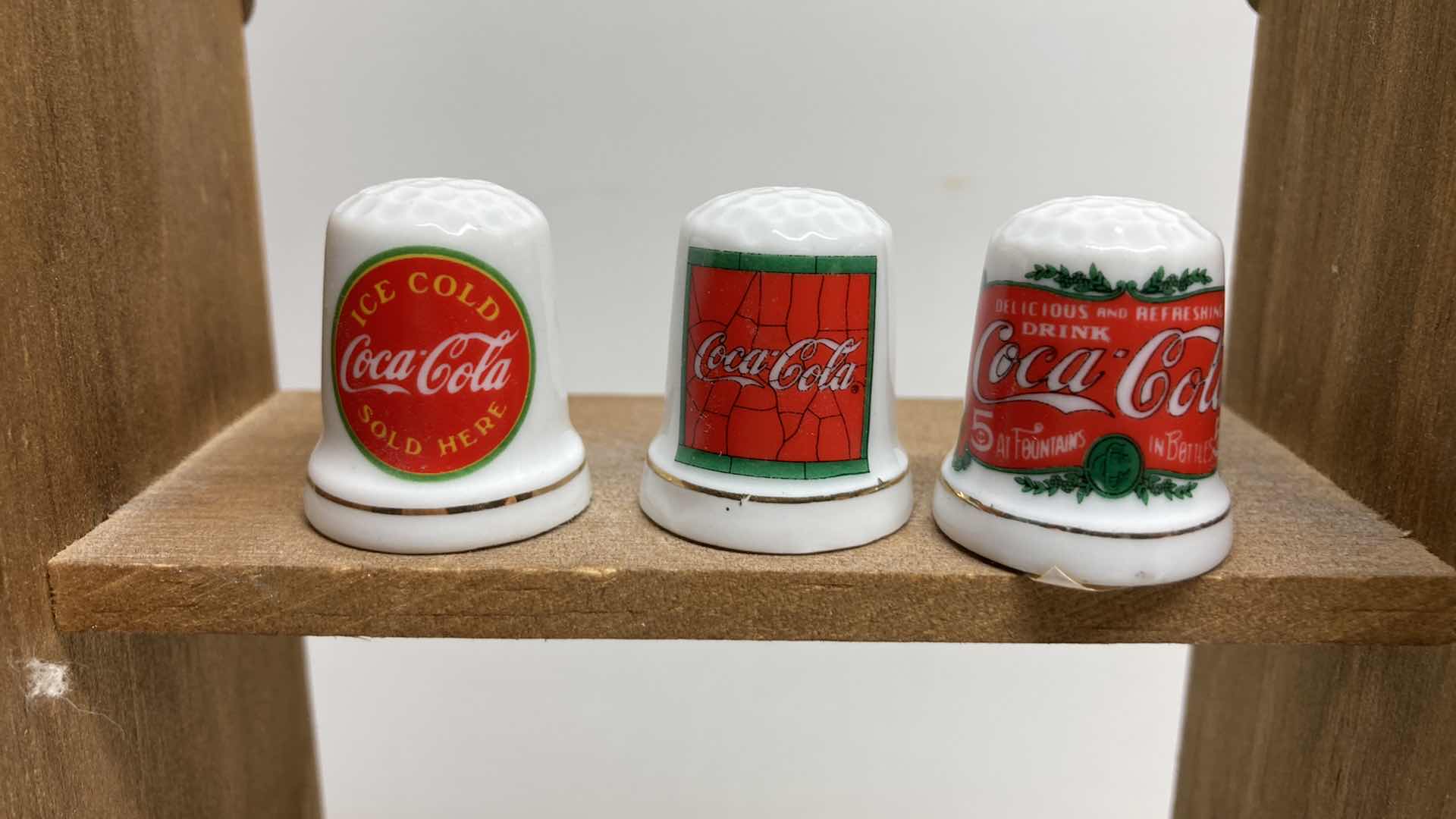 Photo 1 of COCA-COLA THIMBLES W WOOD RACK 4.5” X 3” H8”