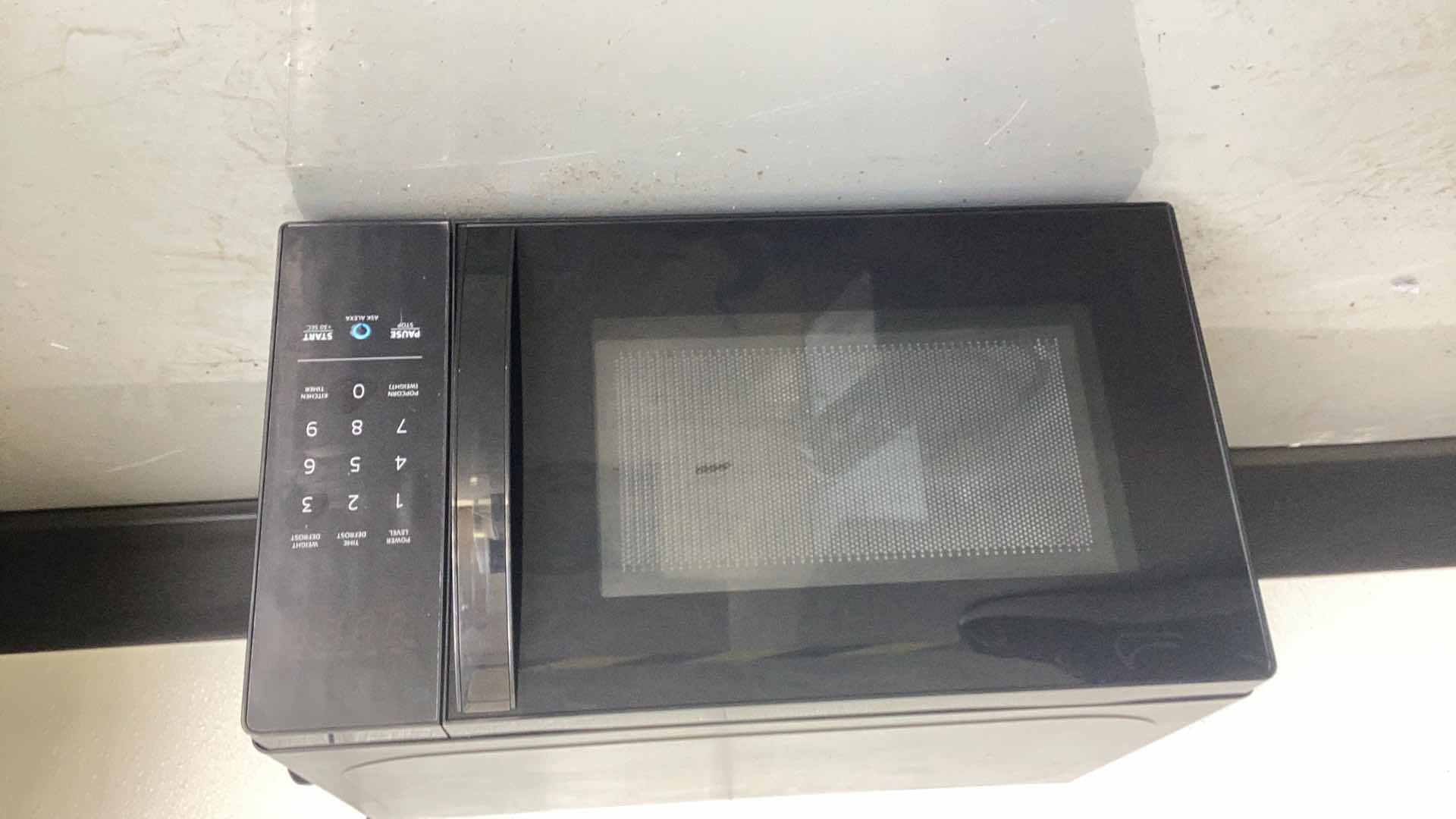 Photo 1 of AMAZON BASICS SMALL MICROWAVE WITH ALEXA 17” H 10”