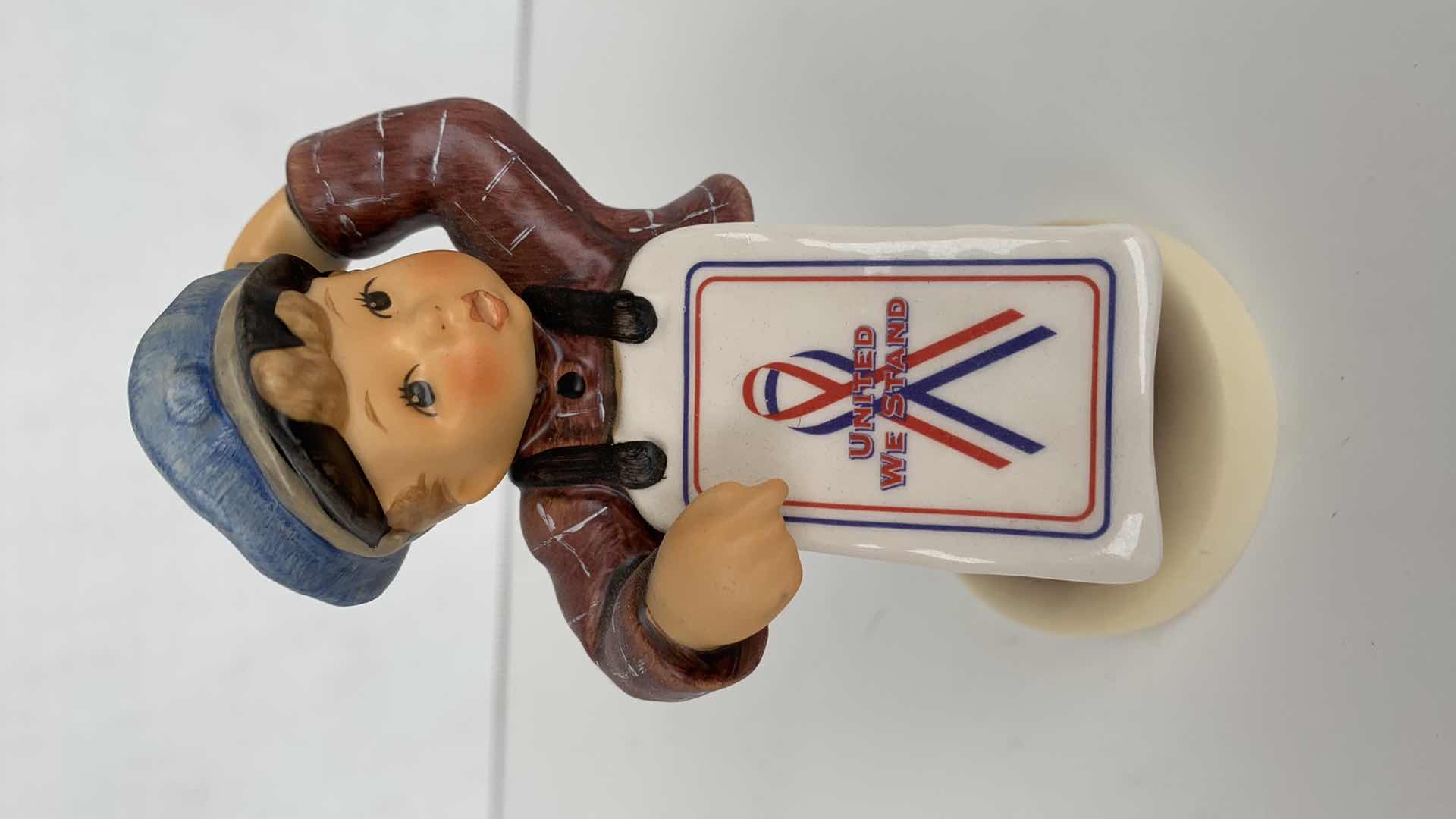 Photo 1 of HUMMEL BOY WEARING GOD BLESS AMERICA SIGN