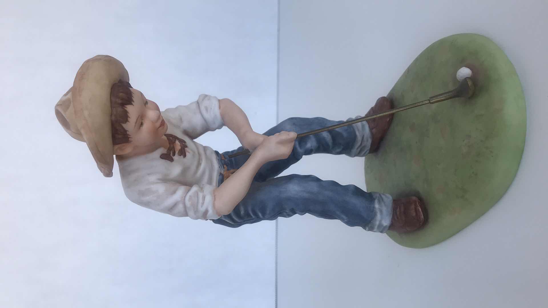 Photo 1 of HUMMEL BOY PLAYING GOLF