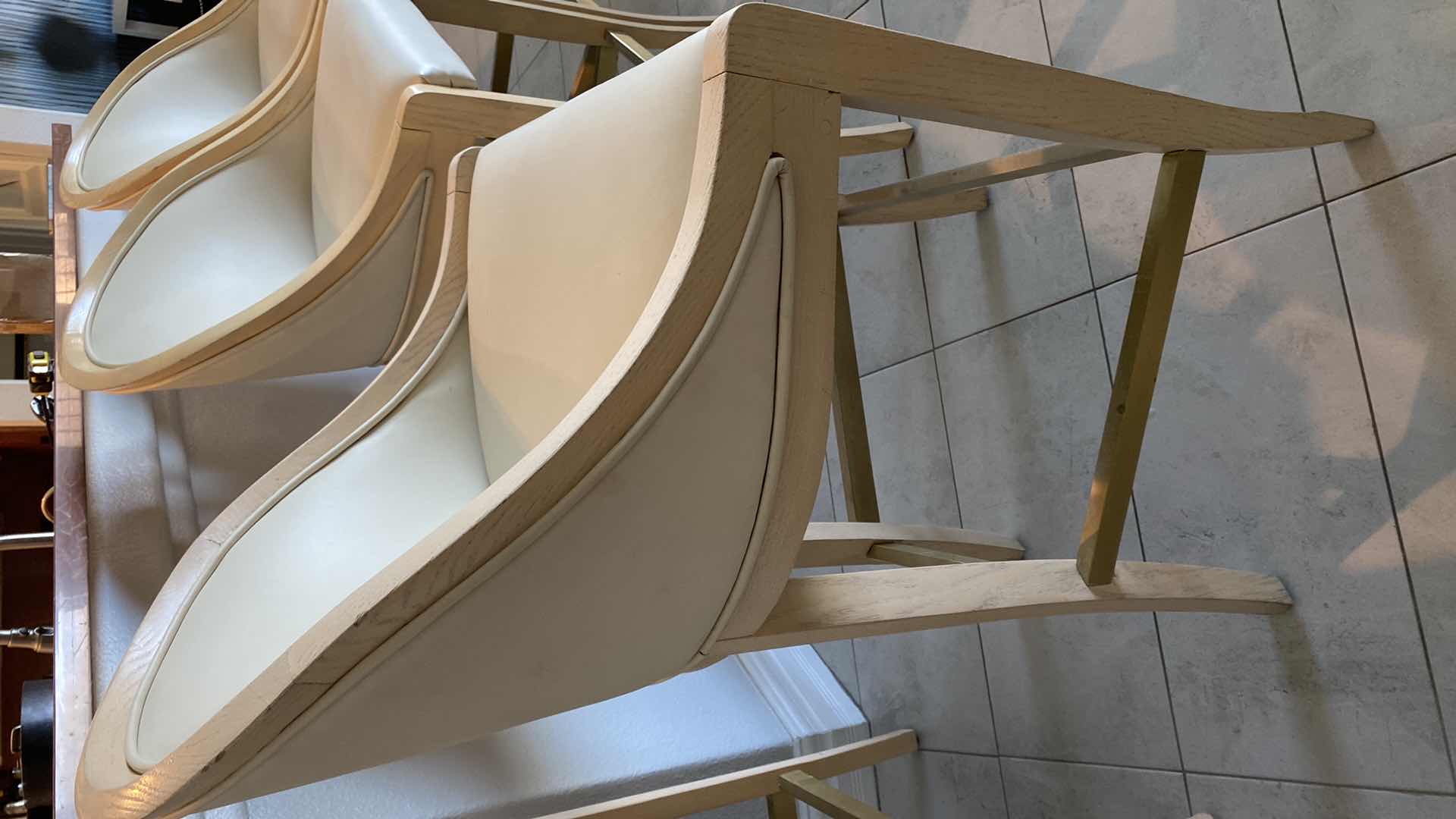 Photo 1 of 4 - CREAM COLOR LEATHER WITH LIGHT WOOD BAR STOOLS FROM THE WYNN - SEAT HEIGHT 31.5”