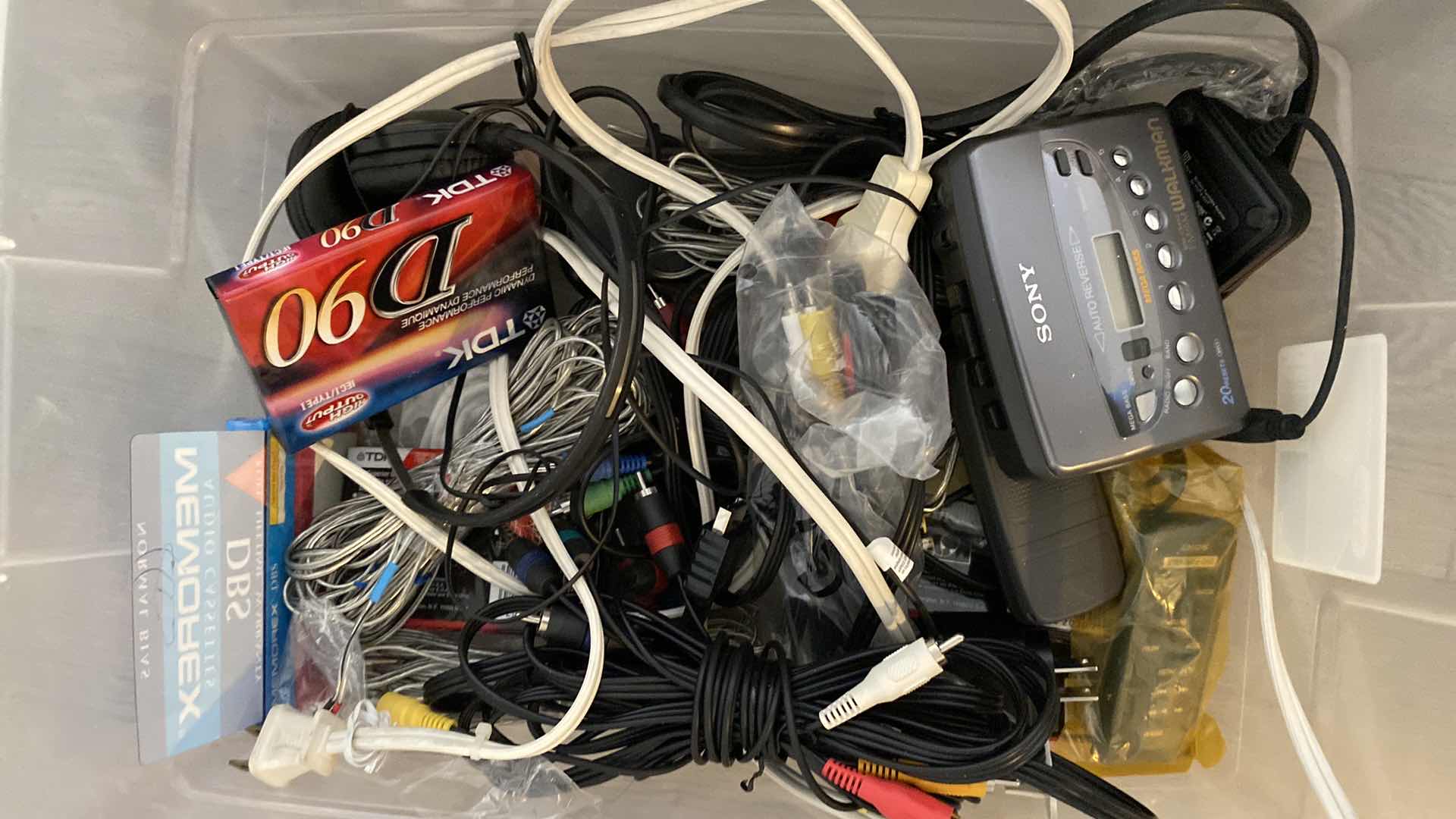 Photo 1 of ASSORTED DVDS AND SONY WALKMAN AND MISC CORDS