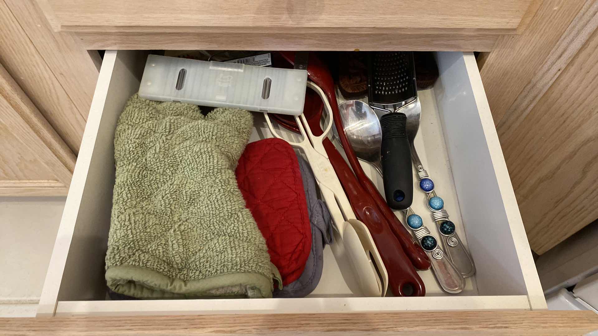 Photo 1 of CONTENTS OF THREE KITCHEN DRAWERS COOKING UTENSILS AND LINENS