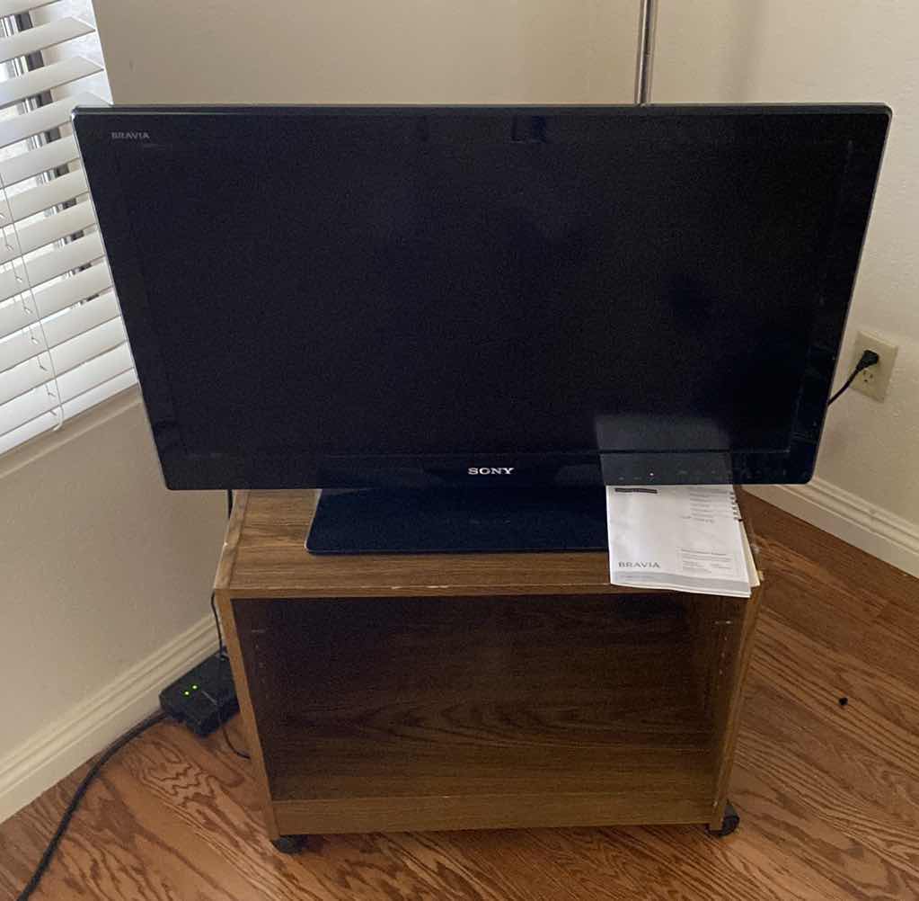 Photo 1 of SONY BRAVIA TV 31” SCREEN WITH REMOTE AND ROLLING TV STAND 
25“ x 16“ H 21 1/2 “
