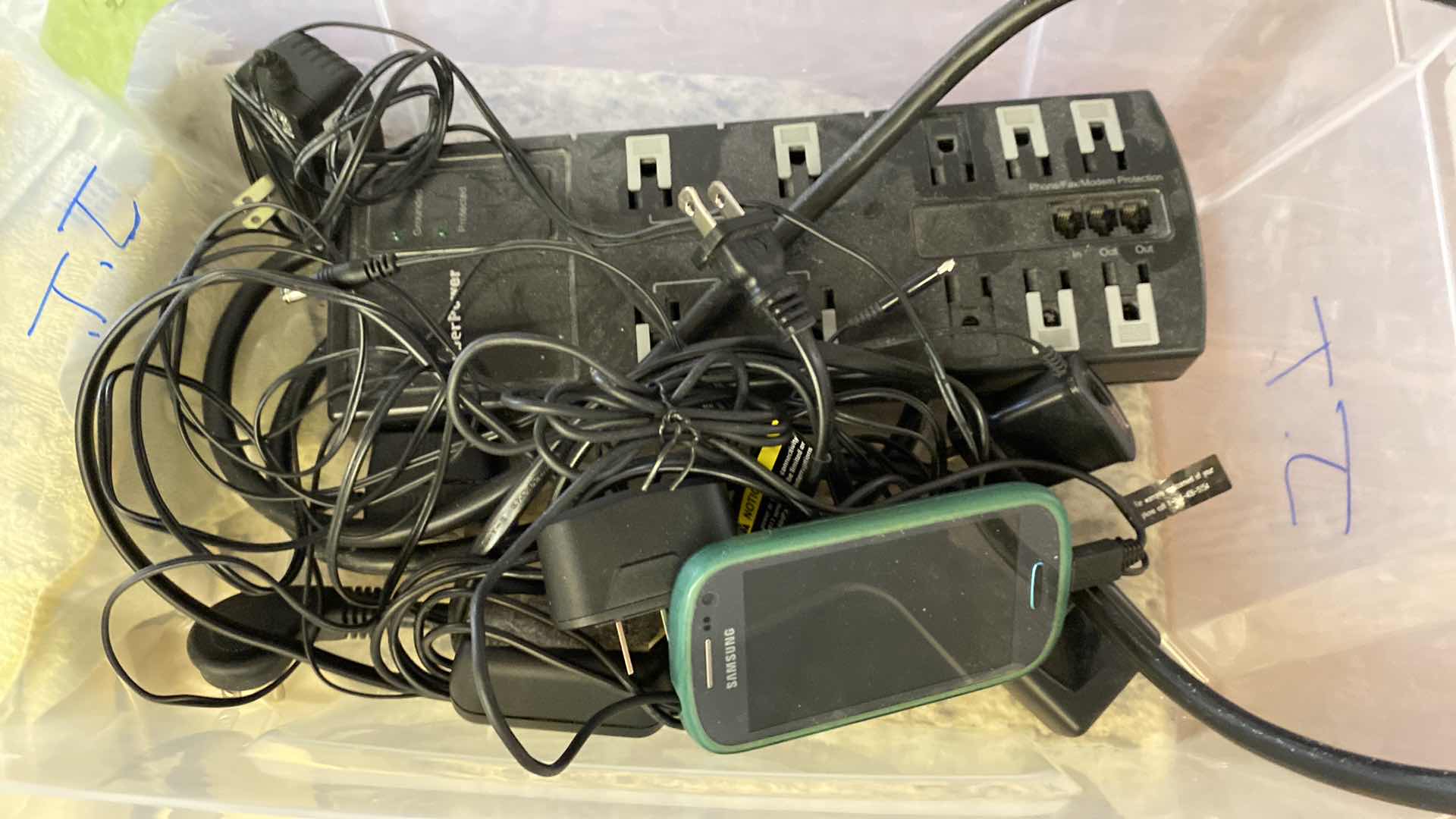 Photo 1 of SAMSUNG PHONE AND ASSORTED CORDS AND POWER STRIP - TOTE NOT INCLUDED