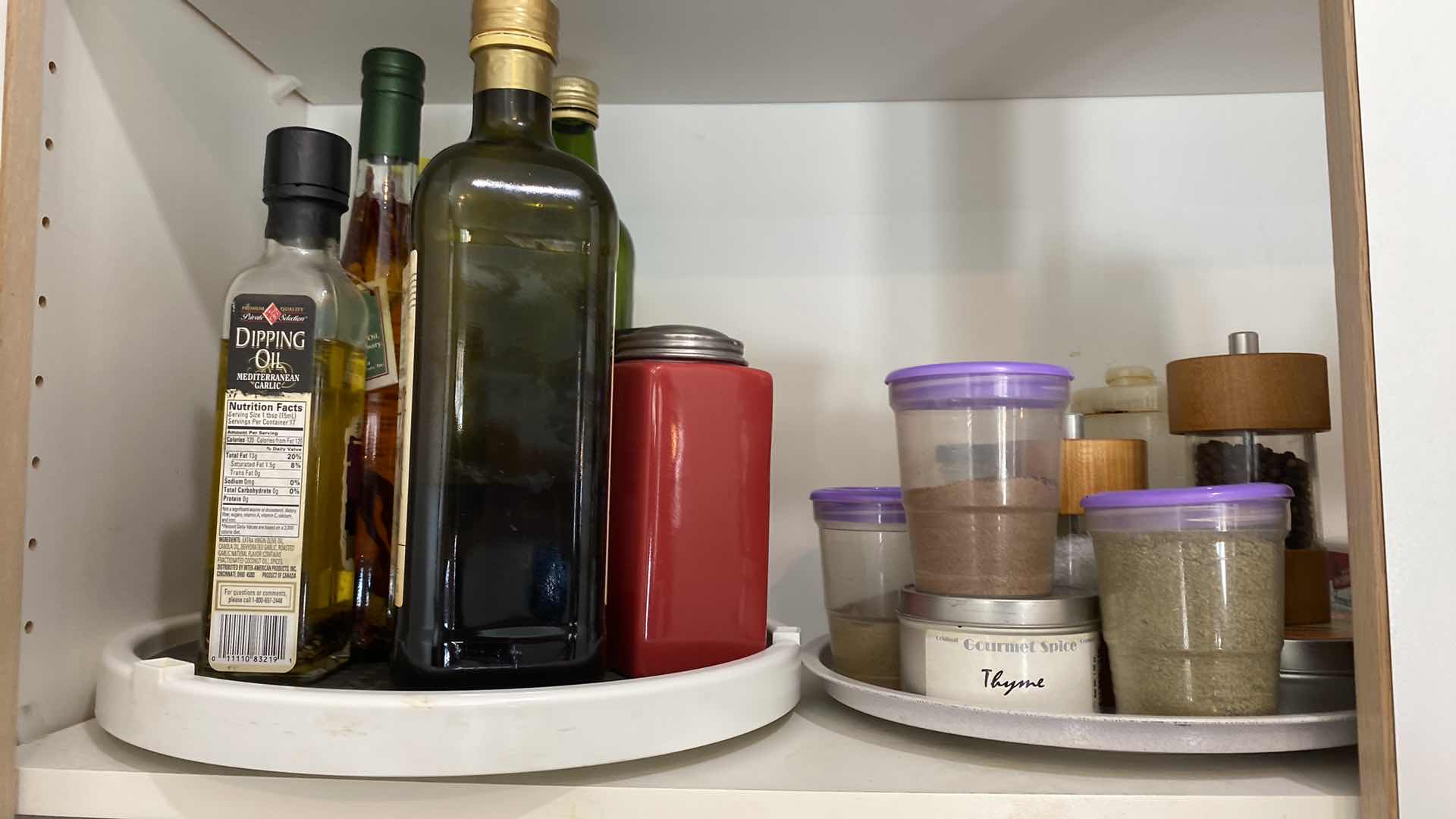 Photo 1 of CONTENTS OF KITCHEN CABINET SPICES AND OILS