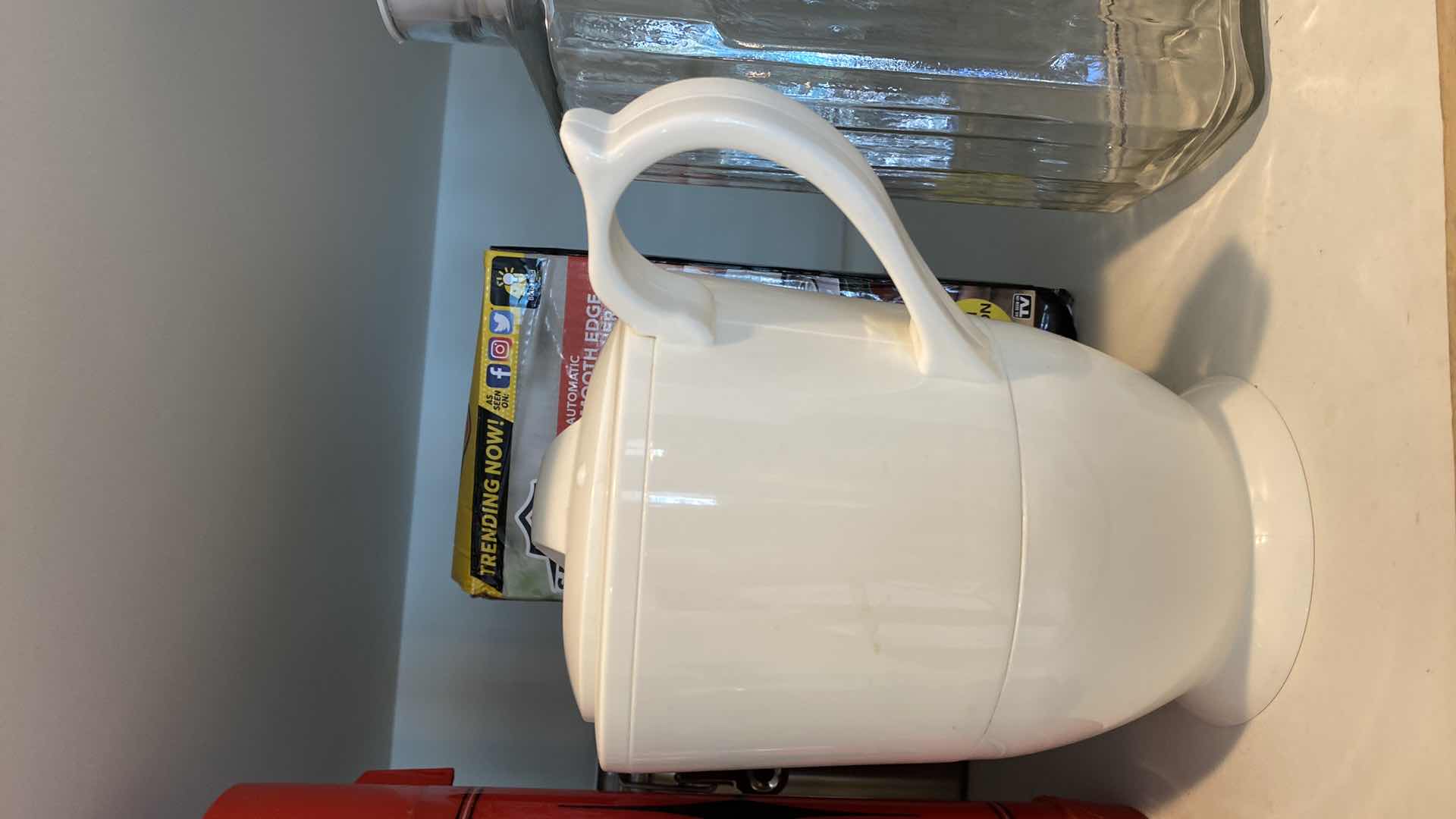 Photo 3 of CONTENTS OF KITCHEN CABINET ABOVE OVEN - GLASS JUICE PITCHERS AND MORE