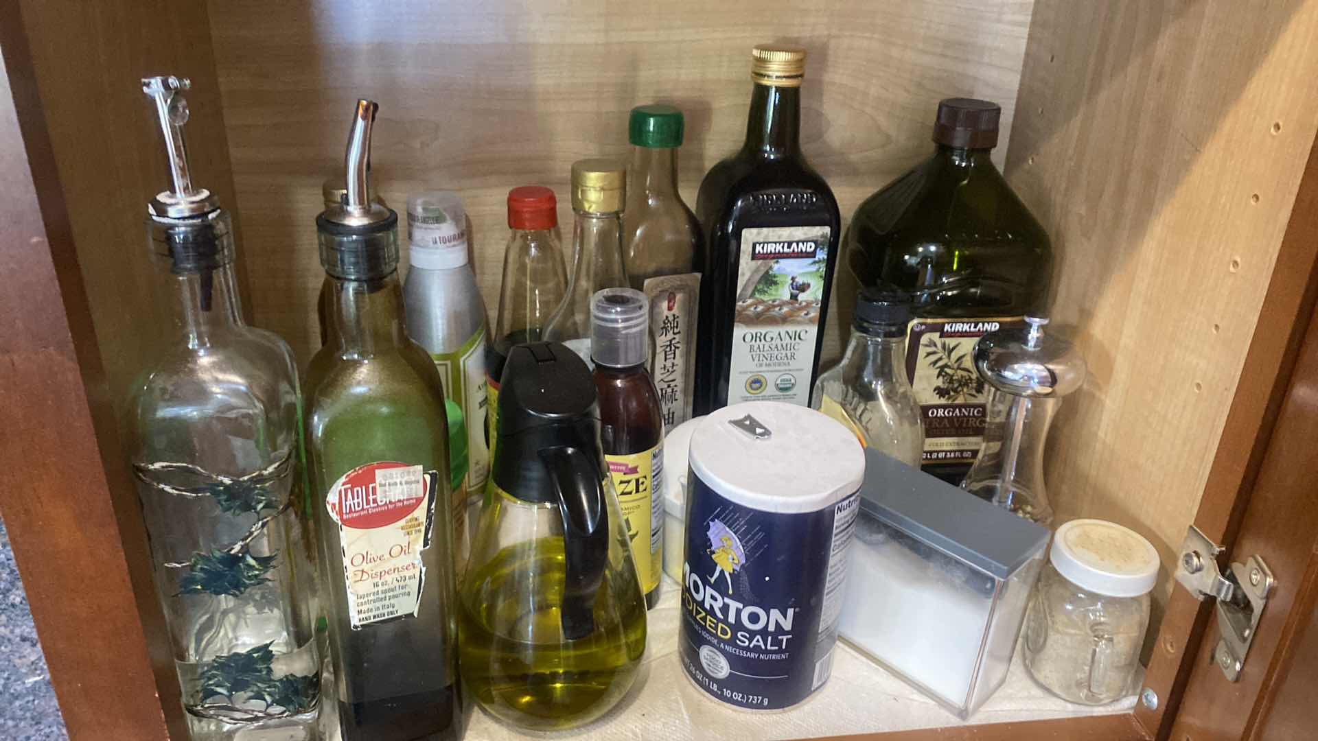 Photo 1 of CONTENTS OF KITCHEN CABINET - OILS AND MORE