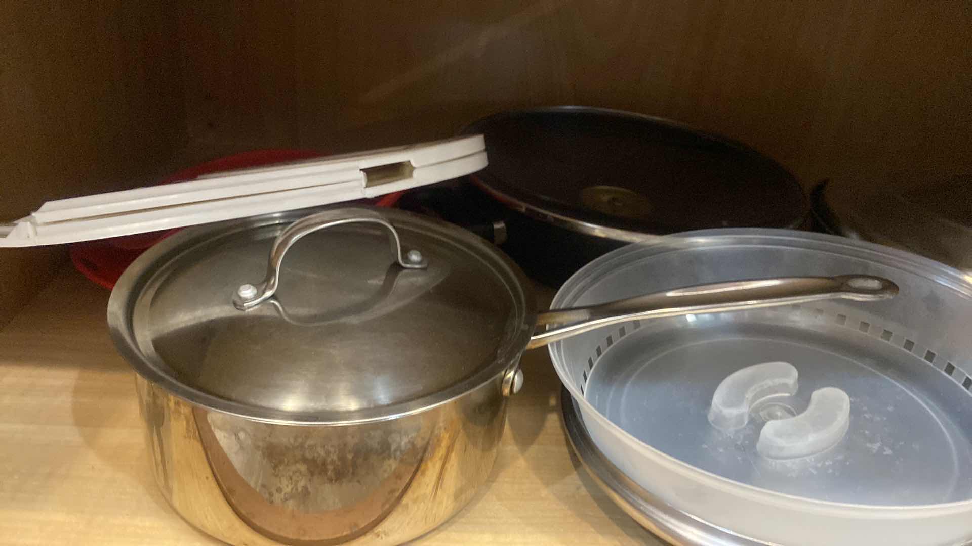 Photo 1 of CONTENTS OF KITCHEN CABINET - POTS & PANS