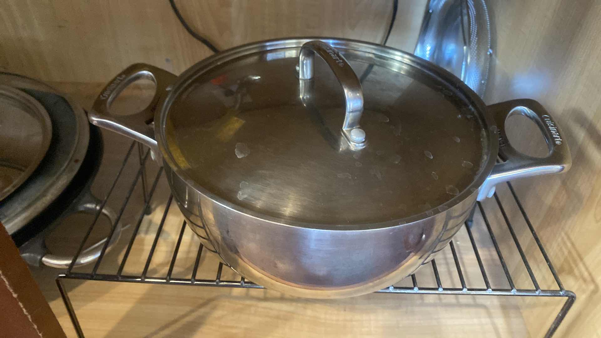 Photo 1 of CONTENTS OF KITCHEN CABINET - CUISINART PAN WITH LID AND A WOK