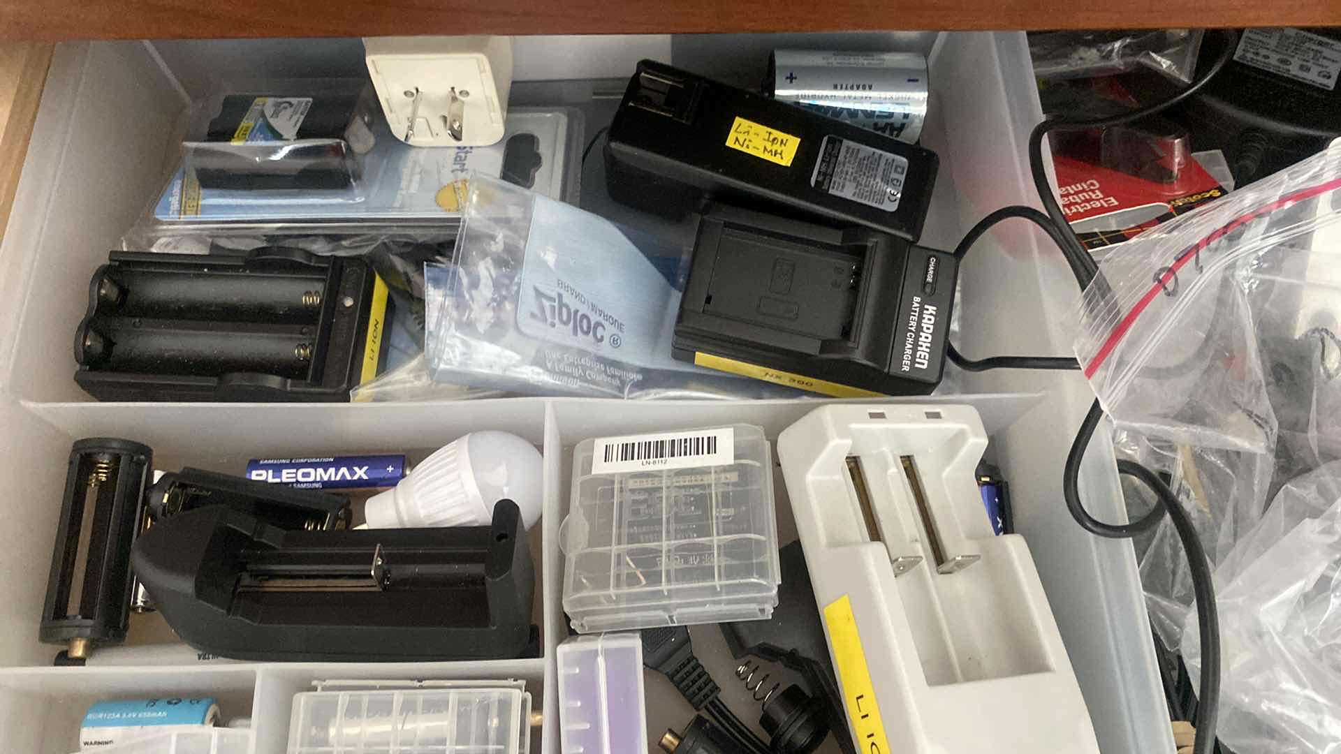 Photo 1 of CONTENTS OF DRAWER IN OFFICE - BATTERIES AND CHARGERS