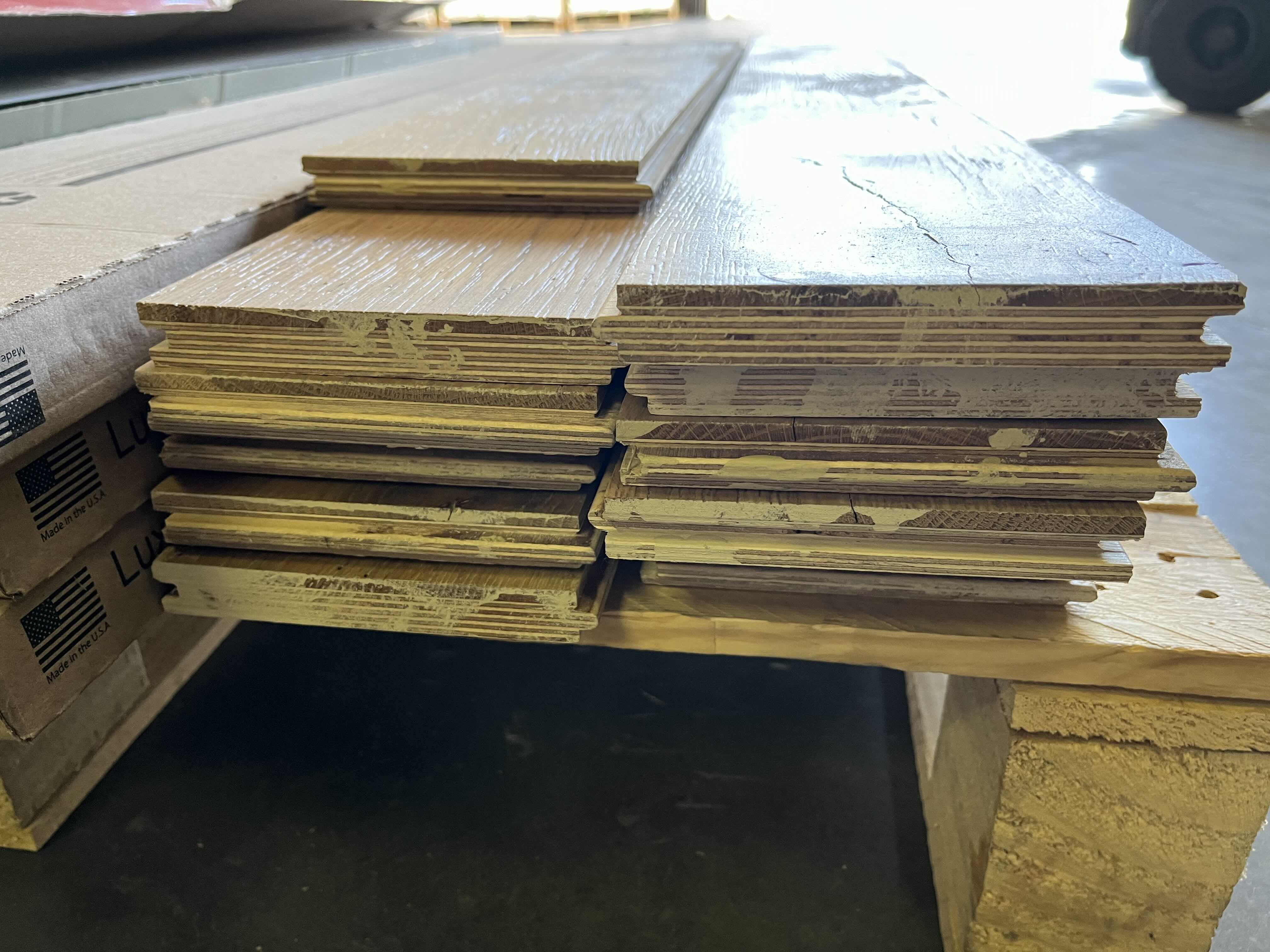 Photo 1 of MIXED FLOORING PALLET-GLUE DOWN/SNAP IN VINYL & HARDWOOD PLANK FLOORING - VARIOUS SIZES & STYLES (READ NOTES)