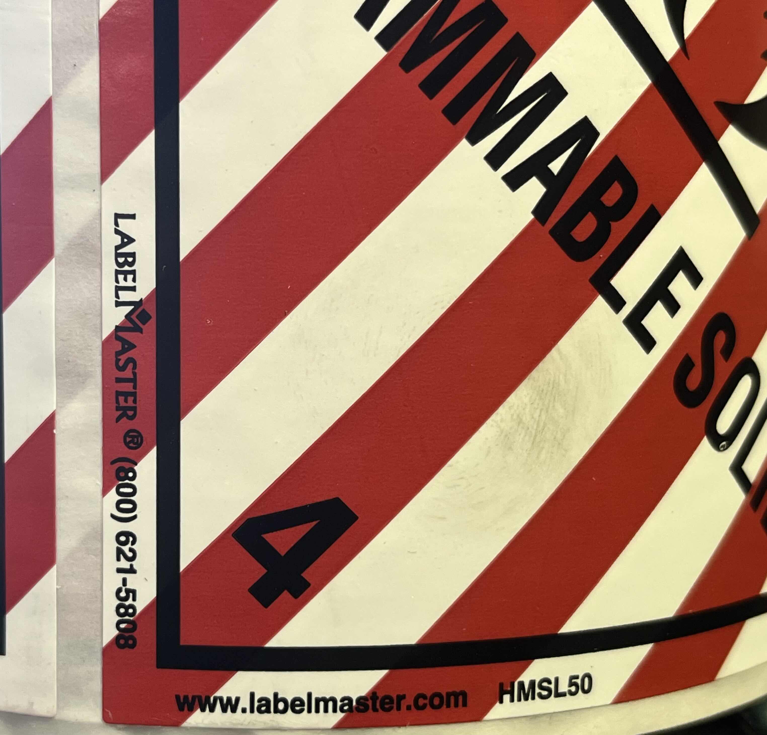 Photo 1 of LABEL MASTER HAZARD CLASS 4 FLAMMABLE SOLID DOT/SHIPPING 500CT 4” ADHESIVE LABEL ROLL HMSL50