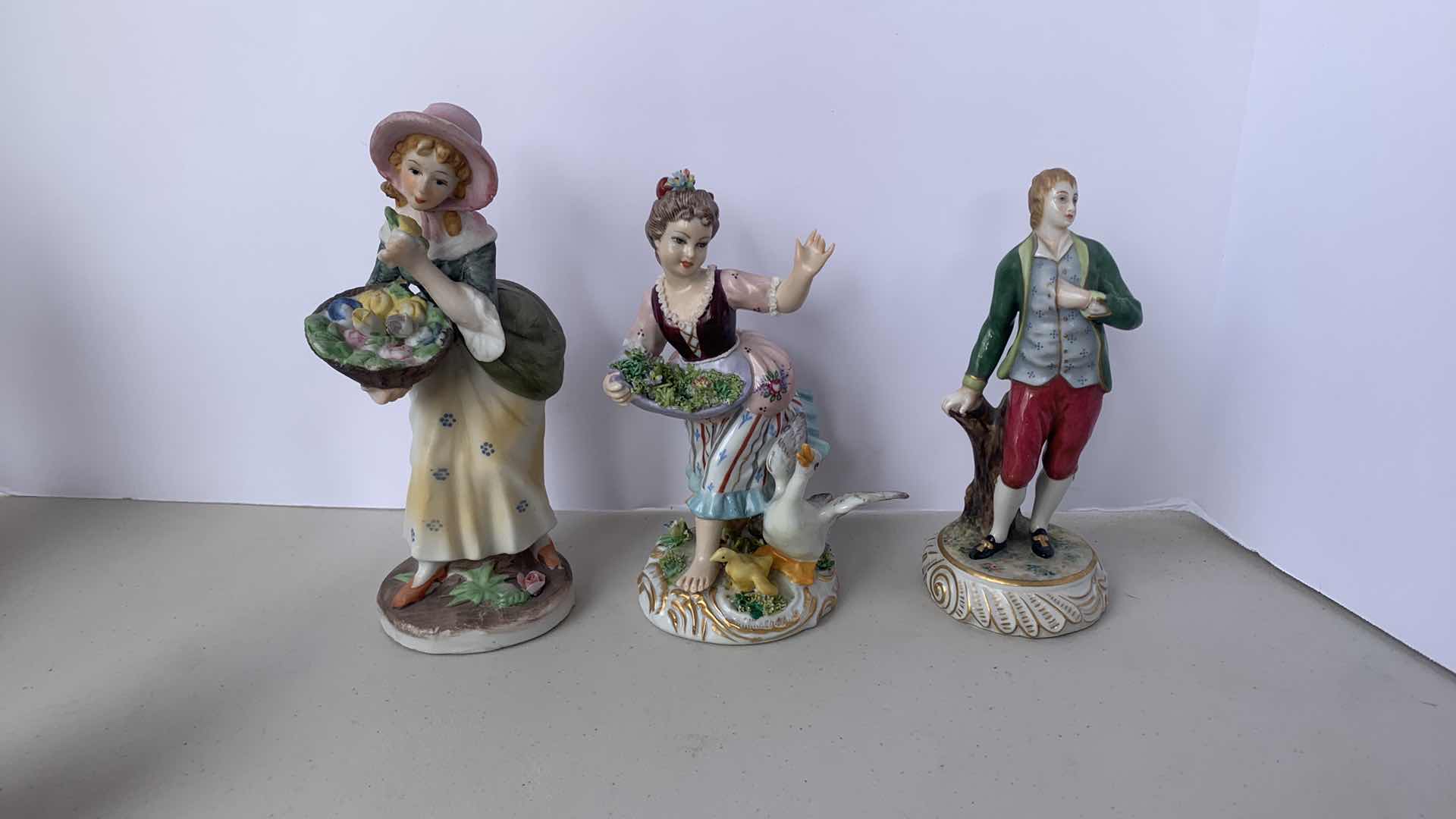 Photo 1 of 7 HANDPAINTED PORCELAIN COLLECTIBLE FIGURINES, ( TALLEST  H 9”)