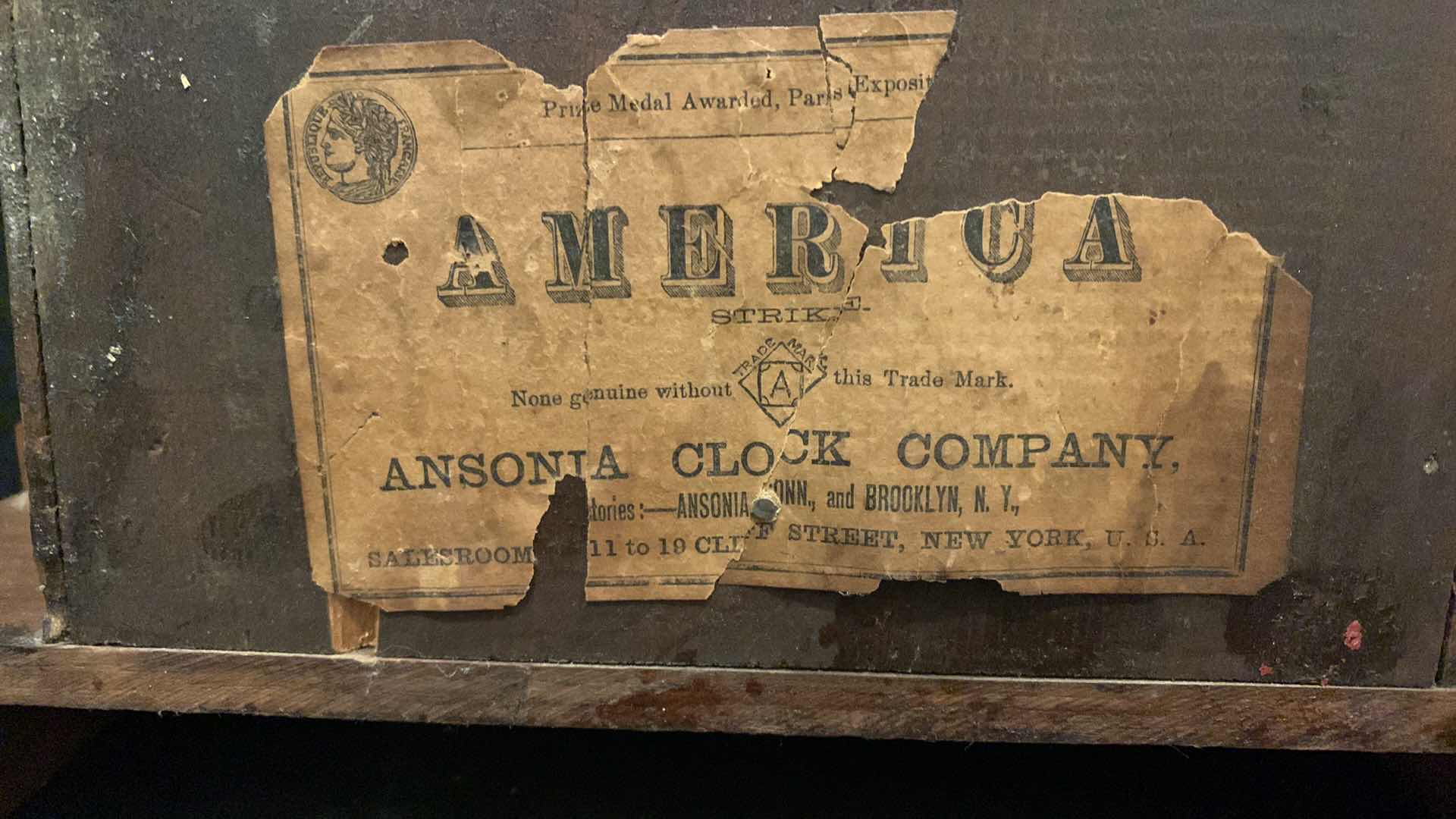 Photo 1 of AMERICA STRIKE WOOD CLOCK BY ANSONIA CLOCK COMPANY 12” x 21.5”