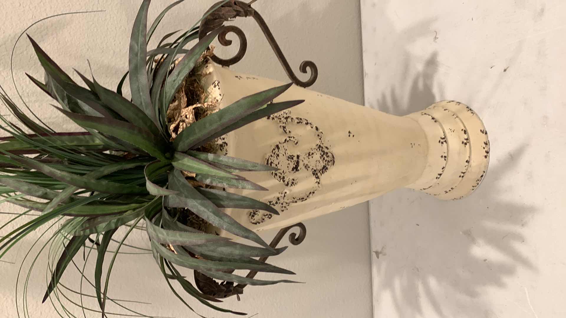 Photo 1 of TALL, PURPOSELY AGED METAL URN W FAUX FLOWER ARRANGEMENT