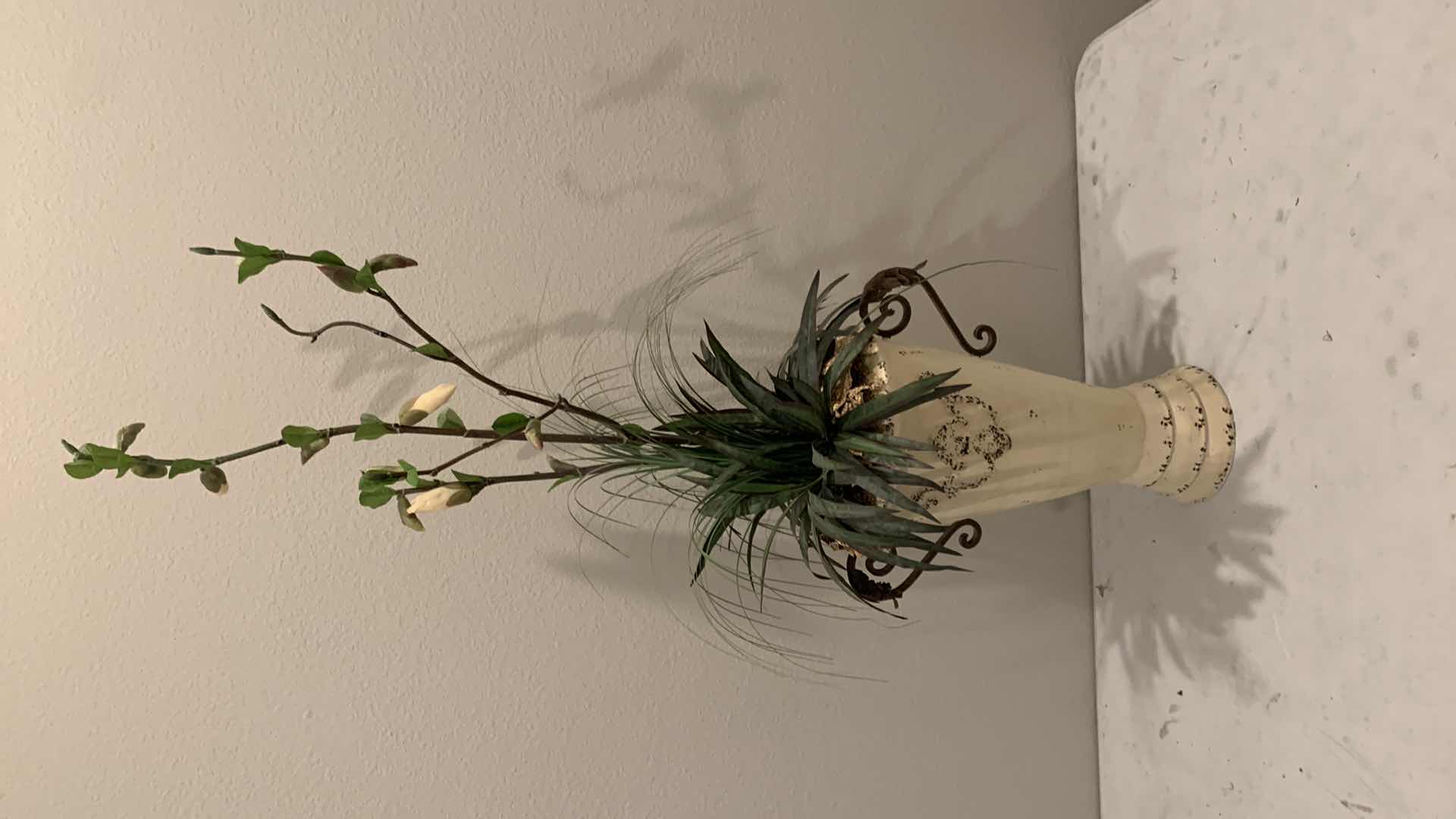 Photo 1 of TALL, PURPOSELY AGED METAL URN W FAUX FLOWER ARRANGEMENT