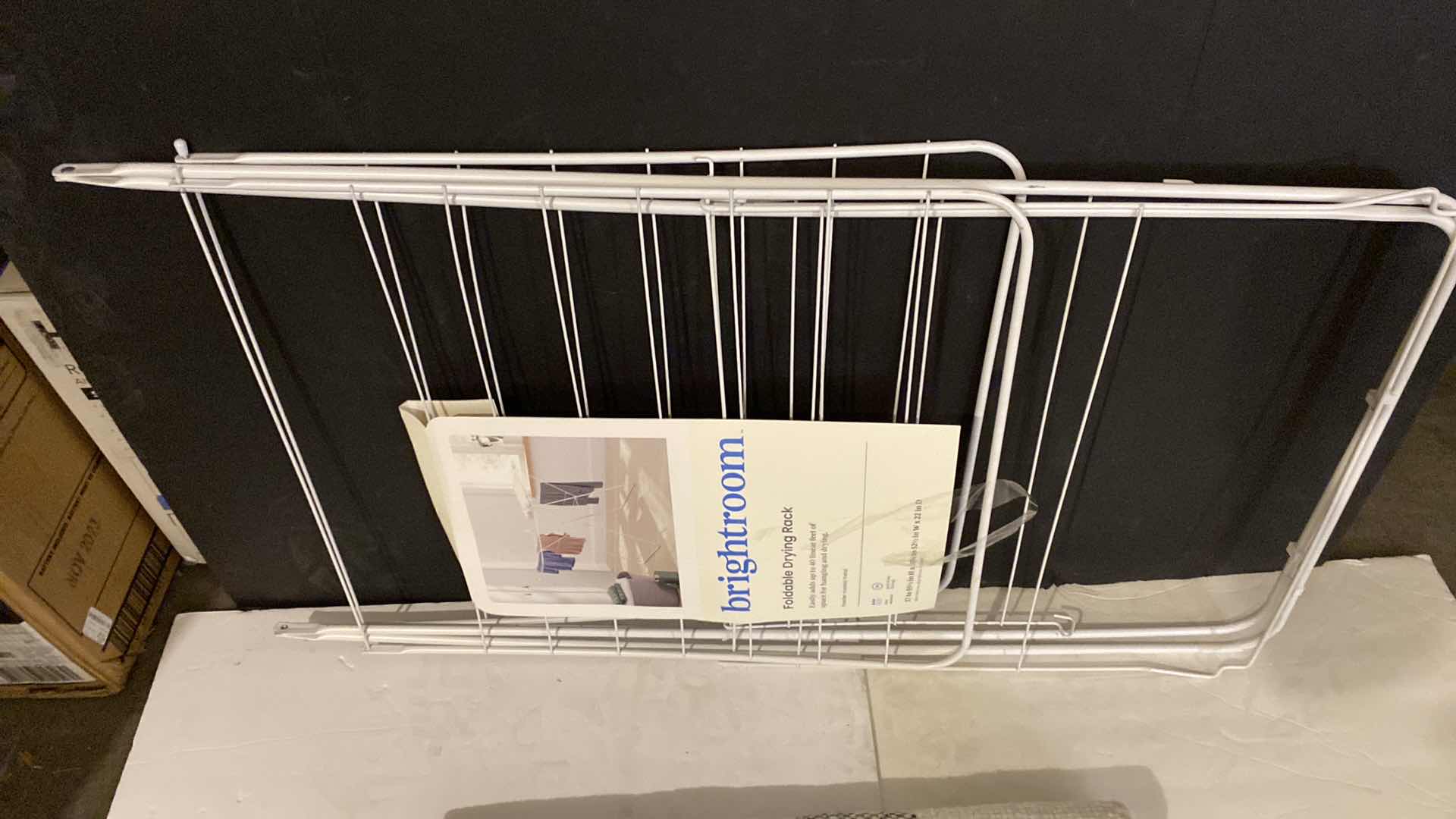 Photo 1 of BRIGHTROOM FOLDABLE DRYING RACK AND GRAY AND WHITE RUG 25” X 38”