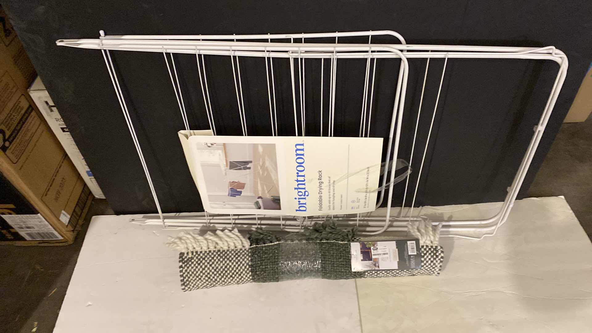 Photo 1 of BRIGHTROOM FOLDABLE DRYING RACK AND GRAY AND WHITE RUG 25” X 38”