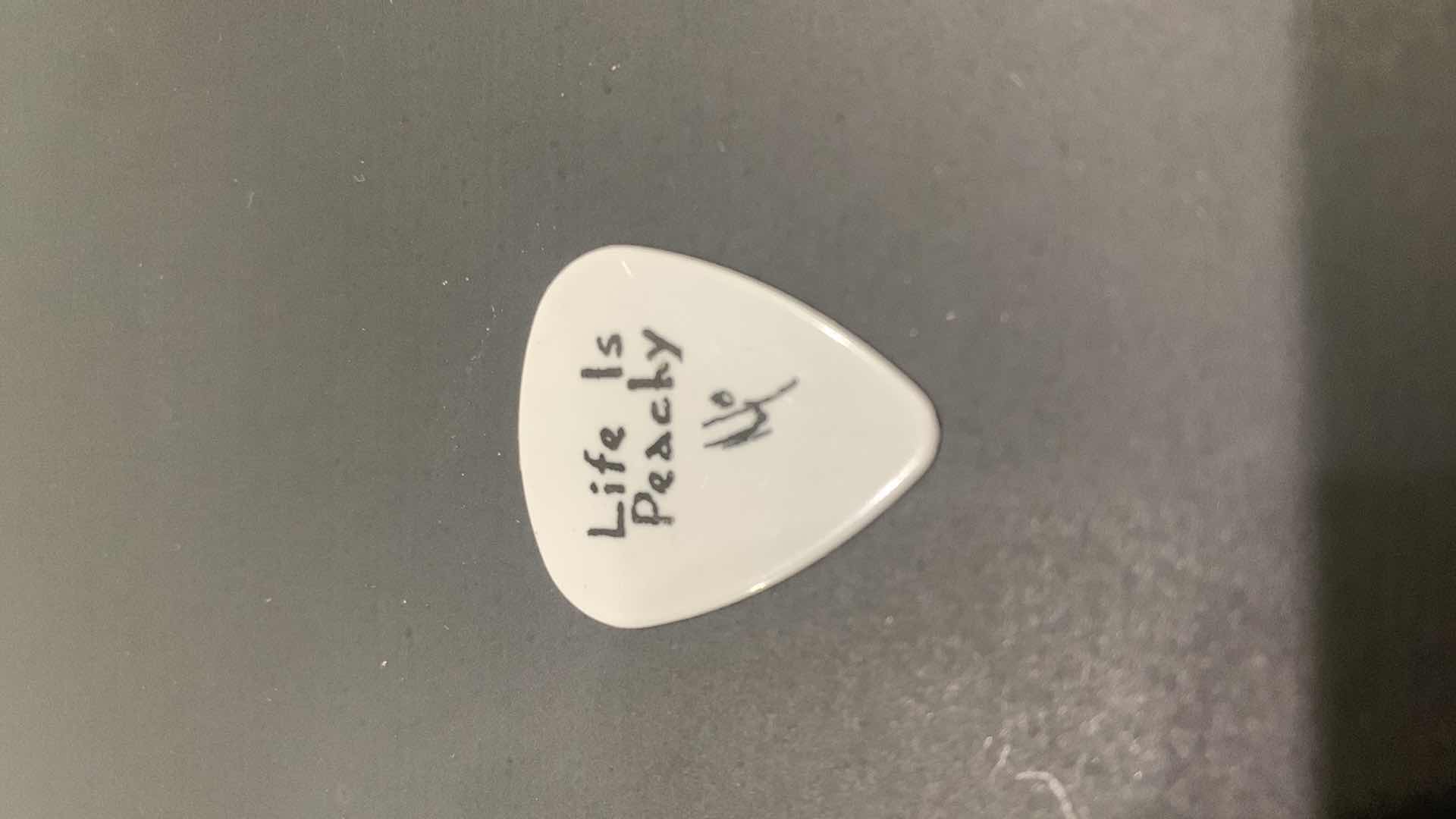 Photo 1 of COLLECTIBLE MEMORABILIA SIGNED GUITAR PICK, KORN LIFE IS PEACHY