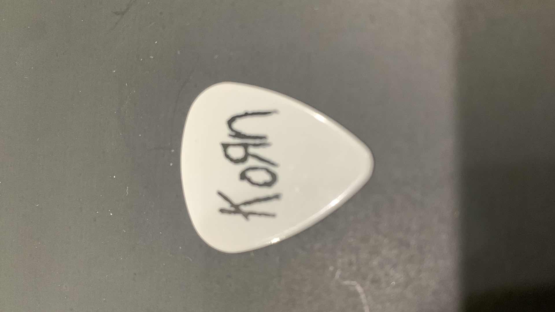 Photo 1 of COLLECTIBLE MEMORABILIA SIGNED GUITAR PICK, KORN LIFE IS PEACHY