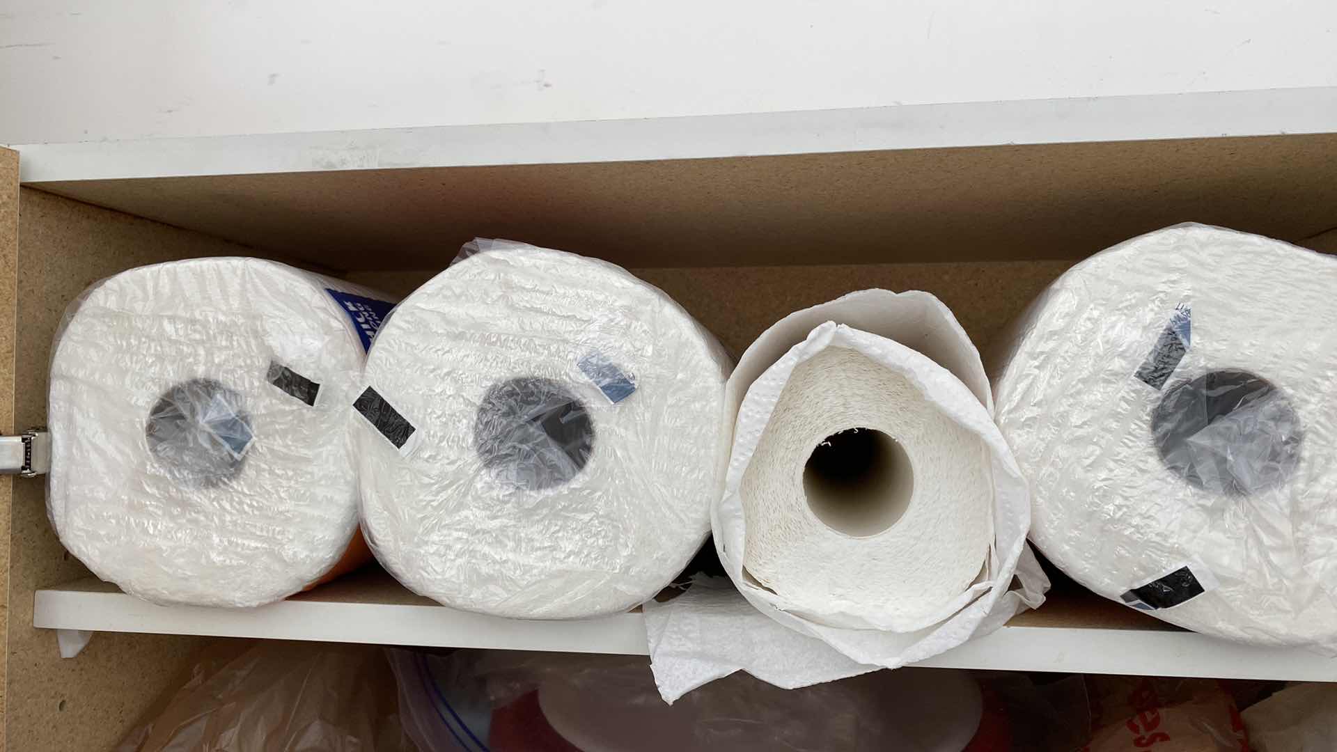 Photo 1 of 2 SHELVES OF PAPER GOODS SILVERWARE TRASH BAGS IN GARAGE