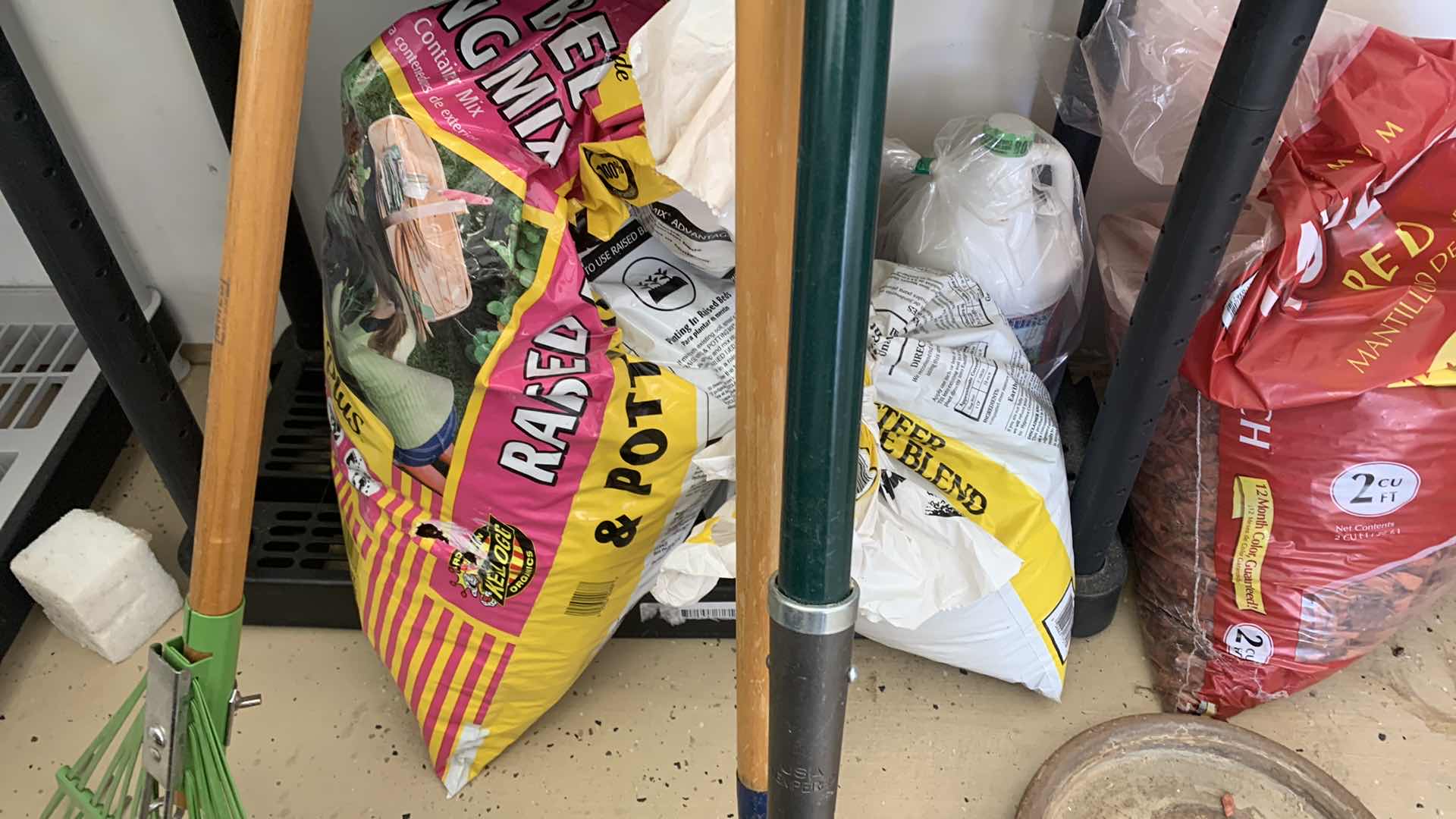 Photo 1 of BLACK SHELF UNIT AND GARDENING SUPPLIES