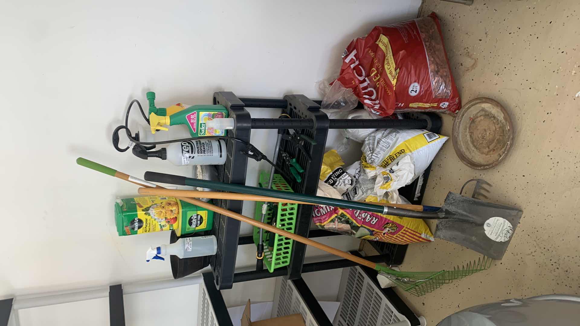 Photo 1 of BLACK SHELF UNIT AND GARDENING SUPPLIES