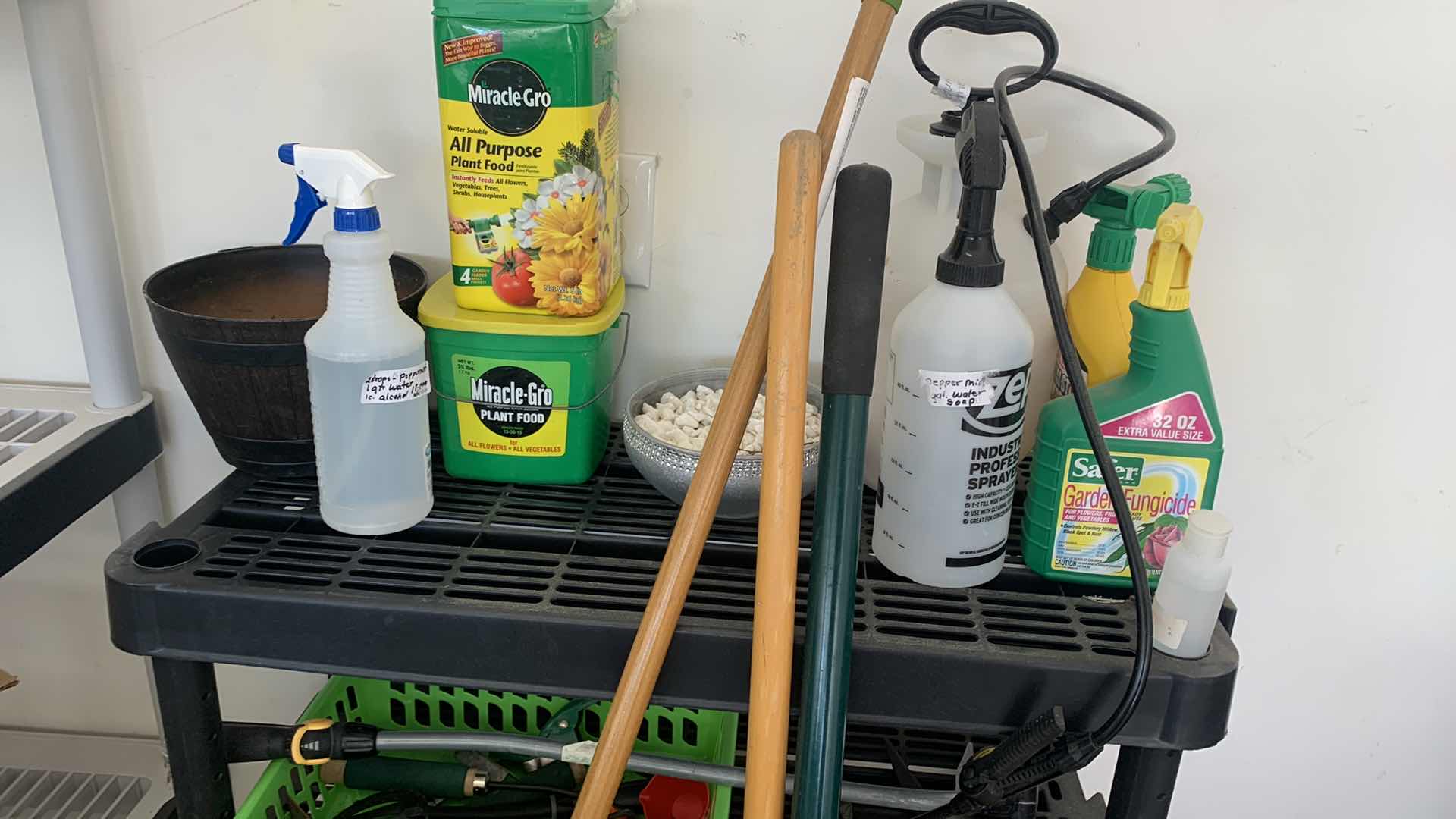 Photo 1 of BLACK SHELF UNIT AND GARDENING SUPPLIES