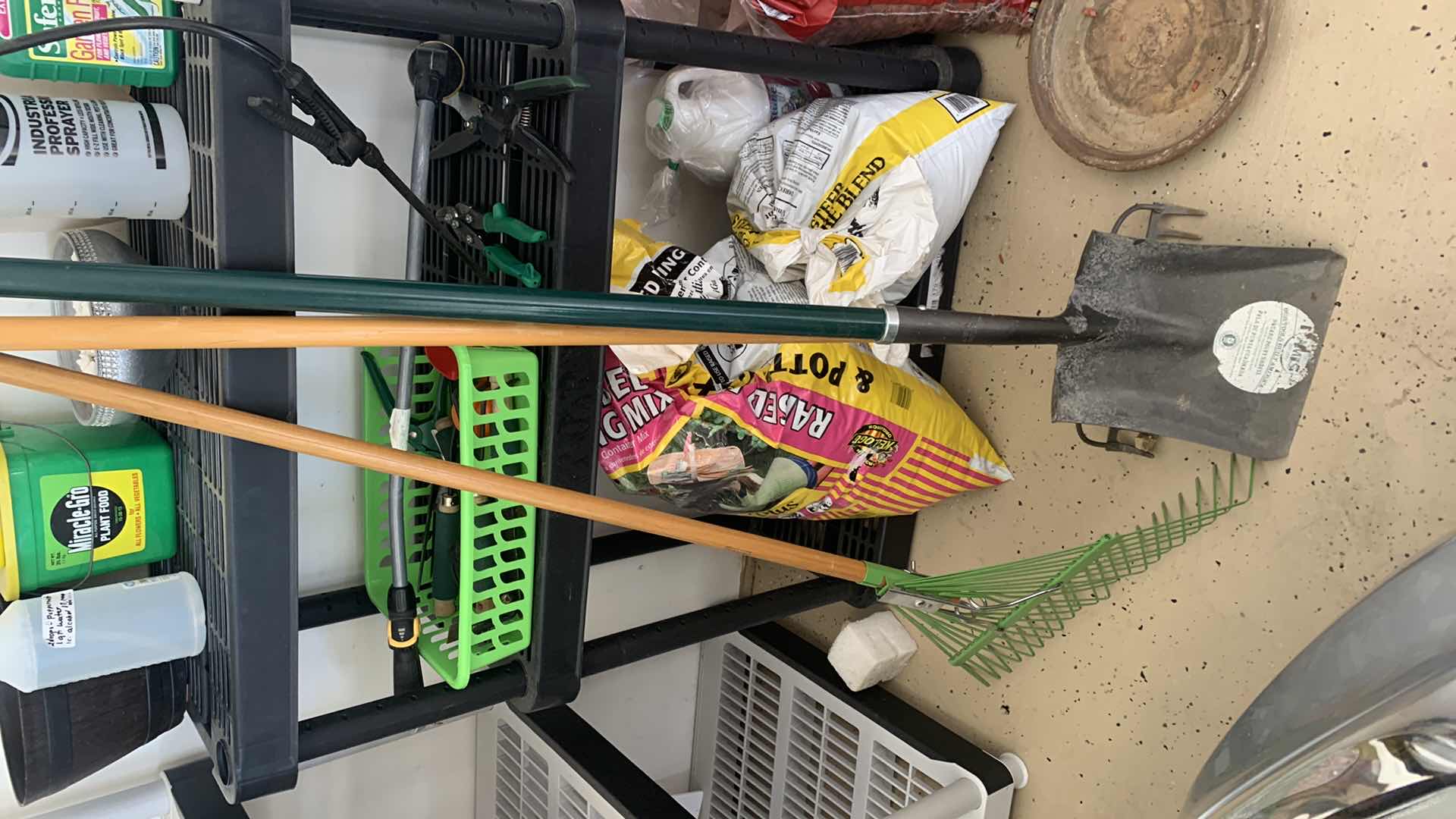 Photo 1 of BLACK SHELF UNIT AND GARDENING SUPPLIES