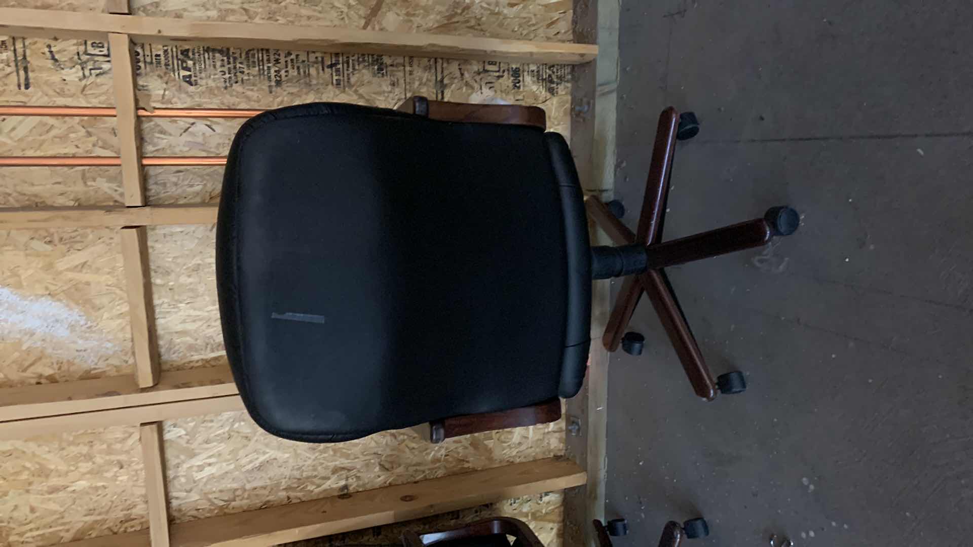 Photo 1 of BLACK WOOD AND BONDED LEATHER OFFICE CHAIR ON WHEELS