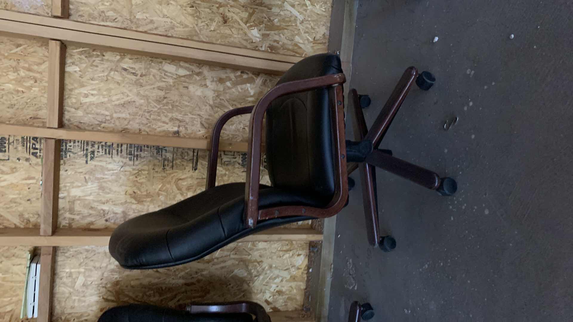 Photo 1 of BLACK WOOD AND BONDED LEATHER OFFICE CHAIR ON WHEELS