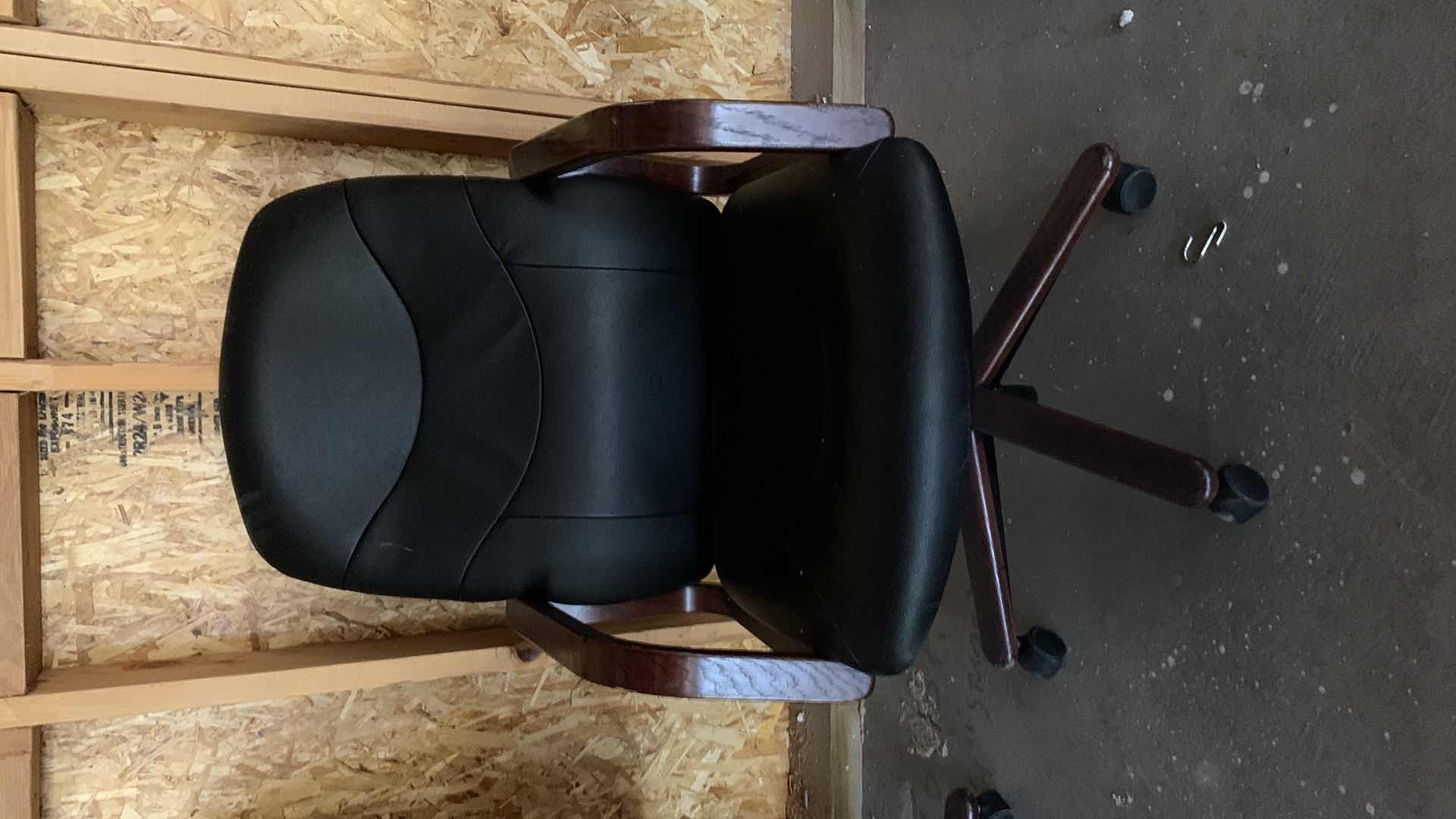 Photo 1 of BLACK WOOD AND BONDED LEATHER OFFICE CHAIR ON WHEELS