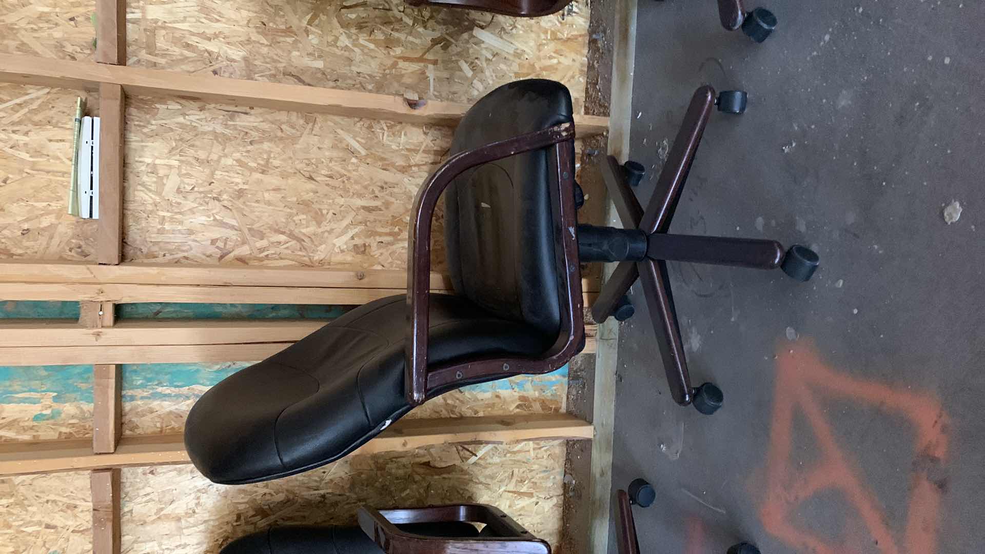 Photo 1 of BLACK WOOD AND BONDED LEATHER OFFICE CHAIR ON WHEELS