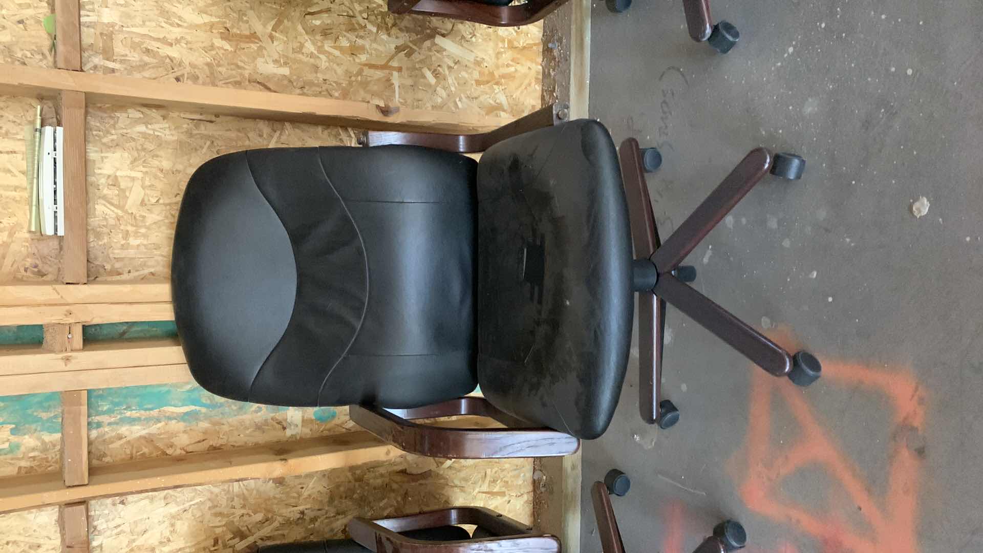 Photo 1 of BLACK WOOD AND BONDED LEATHER OFFICE CHAIR ON WHEELS