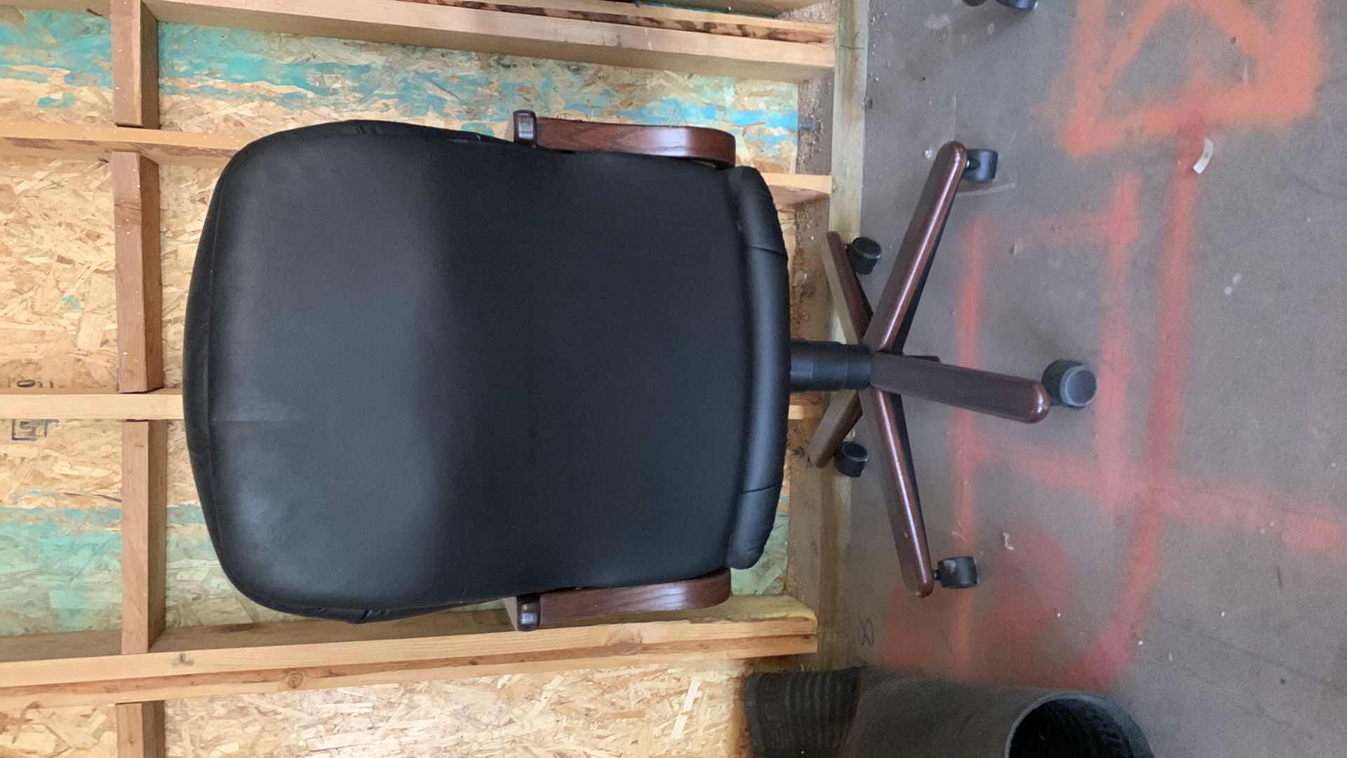 Photo 1 of BLACK WOOD AND BONDED LEATHER OFFICE CHAIR ON WHEELS