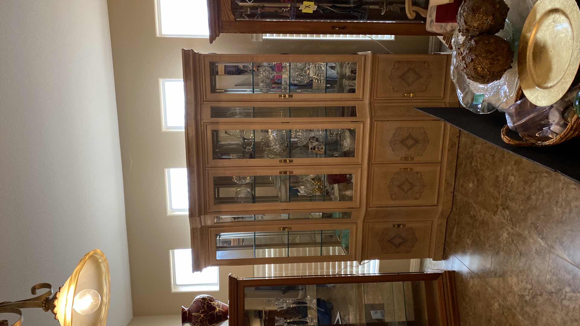 View 2 of BLONDE WOOD CHINA DISPLAY WITH 4 DOORS, 3 DRAWERS AND LIGHTS 68" X 18" H83" (CONTENTS NOT INCLUDED)