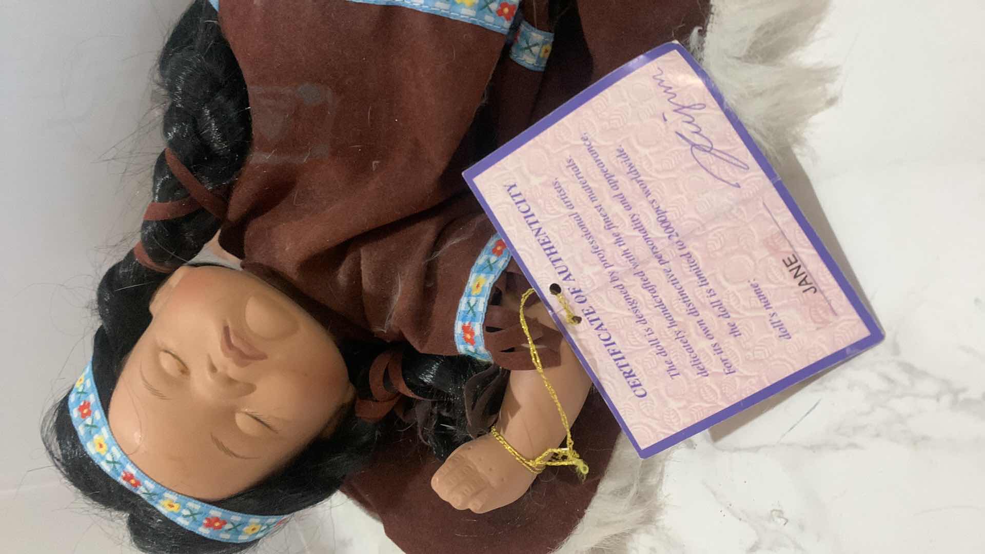 Photo 1 of COLLECTIBLE PORCELAIN INDIAN BABY DOLL w COA 12”