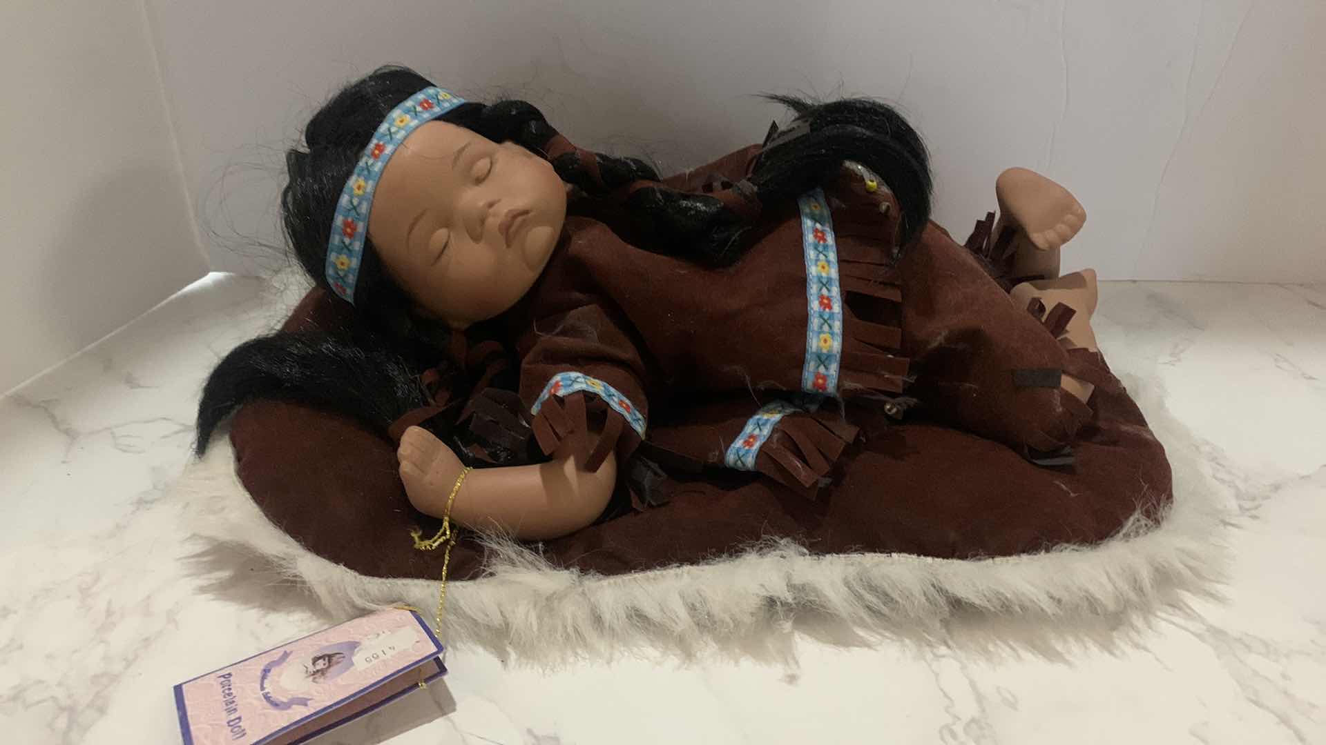 Photo 1 of COLLECTIBLE PORCELAIN INDIAN BABY DOLL w COA 12”