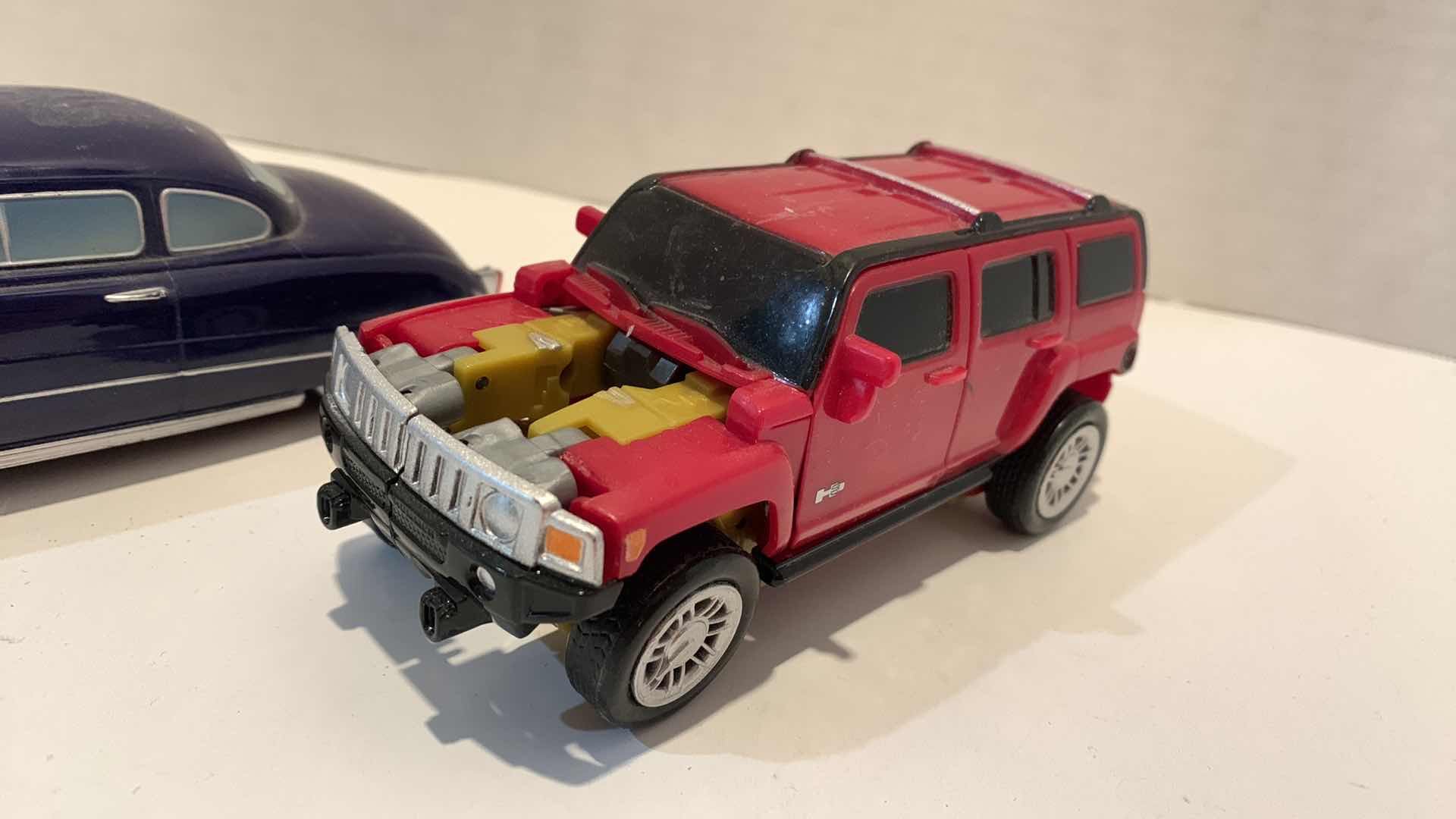 Photo 1 of 2 COLLECTABLE CAR TOYS ONE IS TRANSFORMER