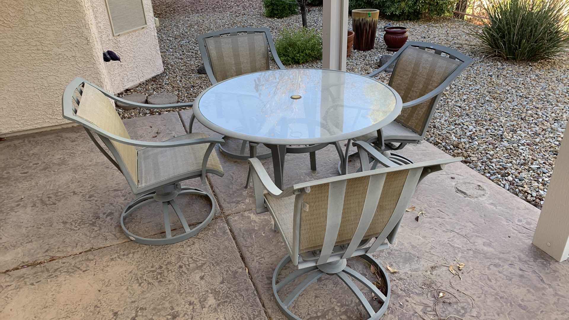 Photo 1 of ALUMINUM PATIO TABLE W 4-SWIVEL ROCKING ARM CHAIRS