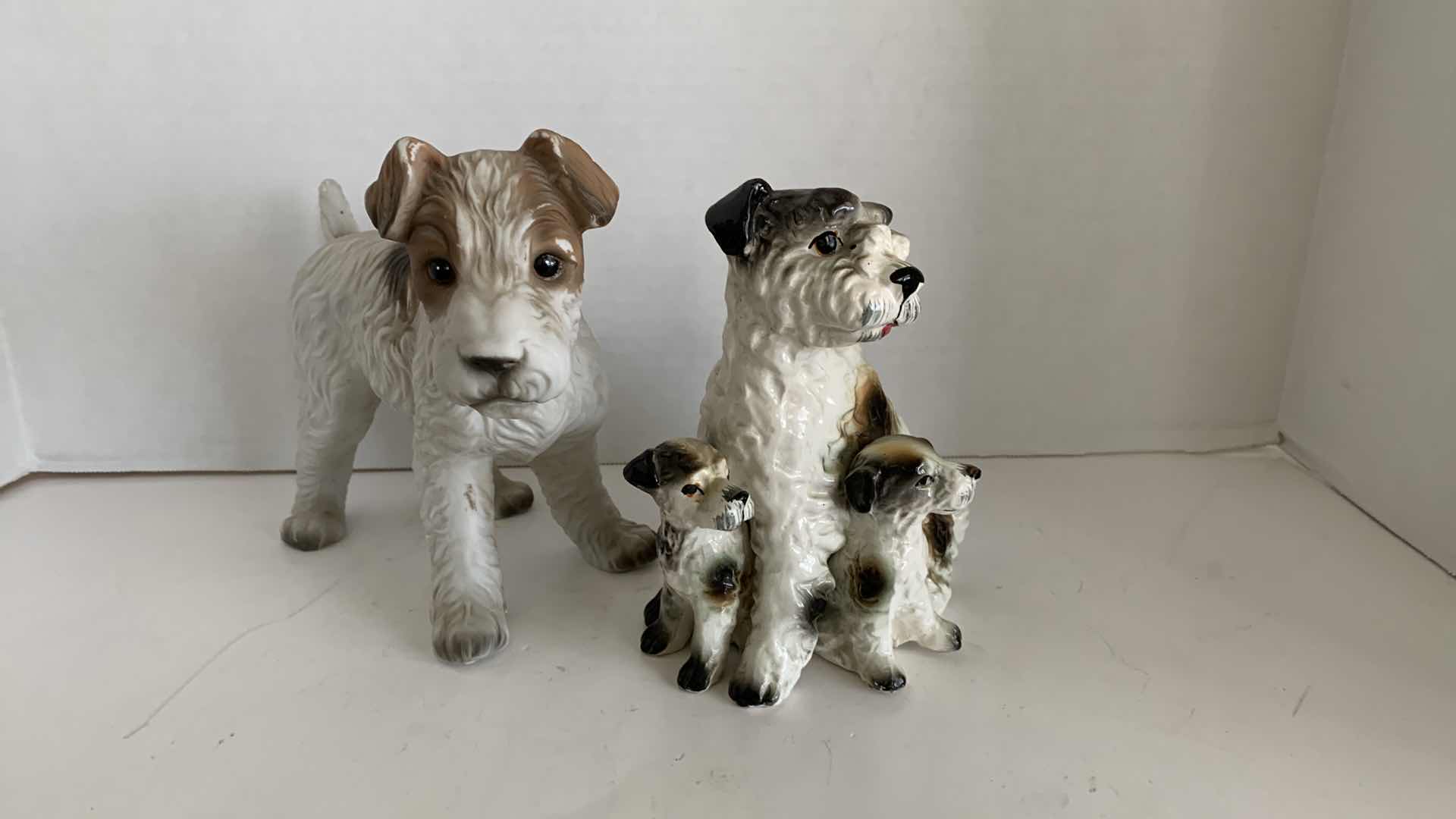 Photo 1 of 2-TERRIER DOG STATUES, TALLEST IS 7”