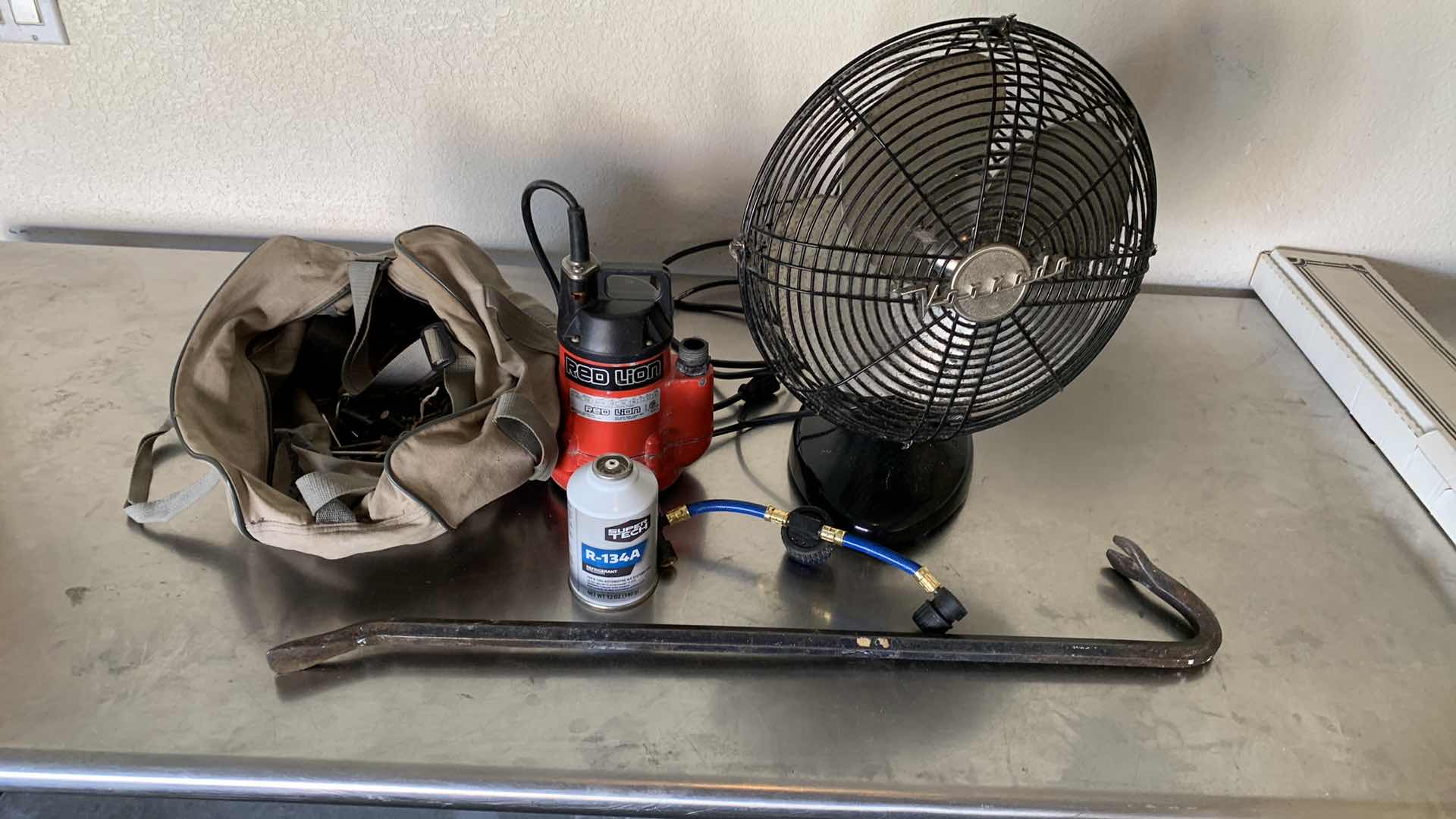 Photo 1 of GARAGE TOOLS AND ASSORTED ITEMS. CROW BAR, UTILITY PUMP, FAN AND NAILS.